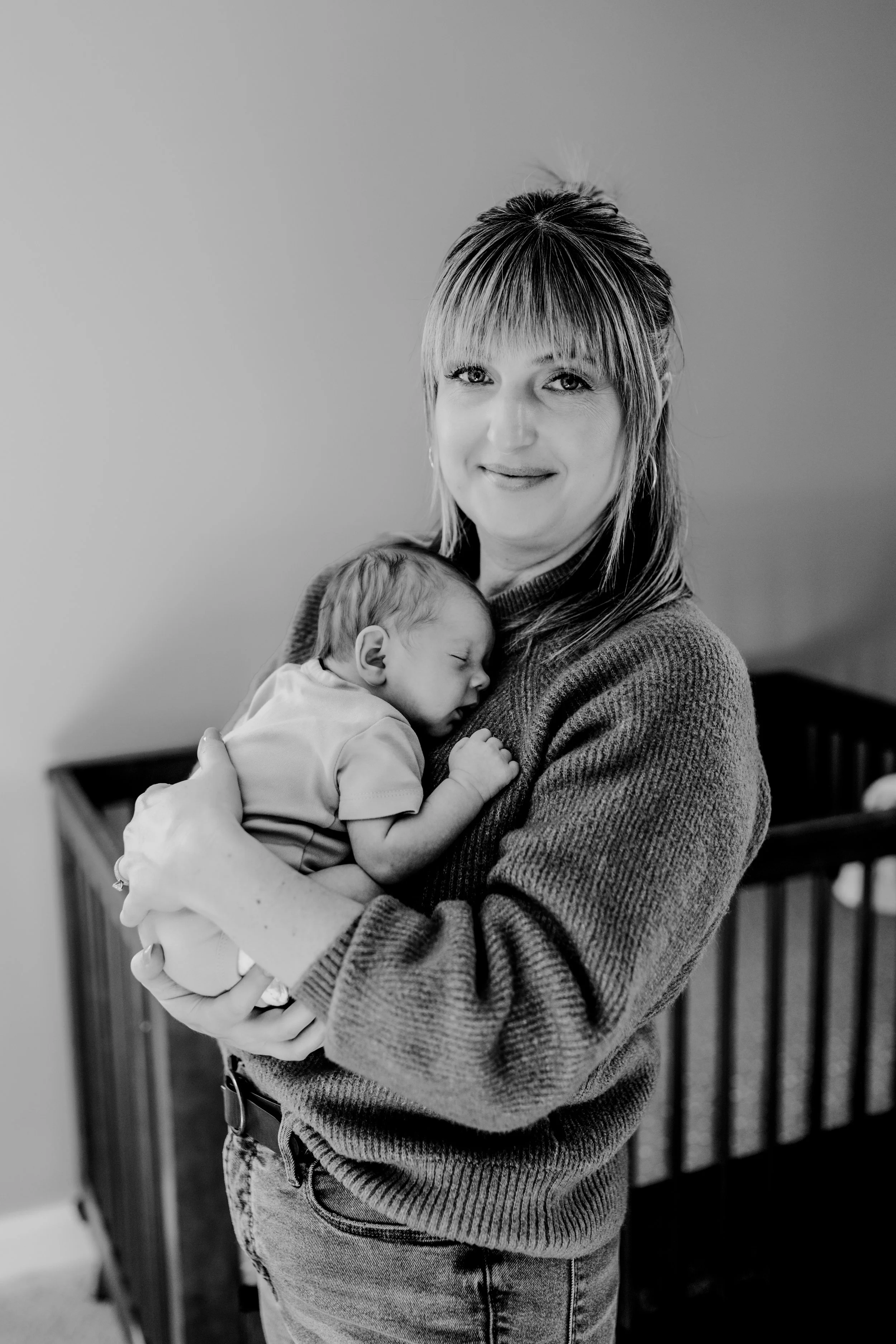 Casual lifestyle newborn photo with baby sleeping on mom’s chest