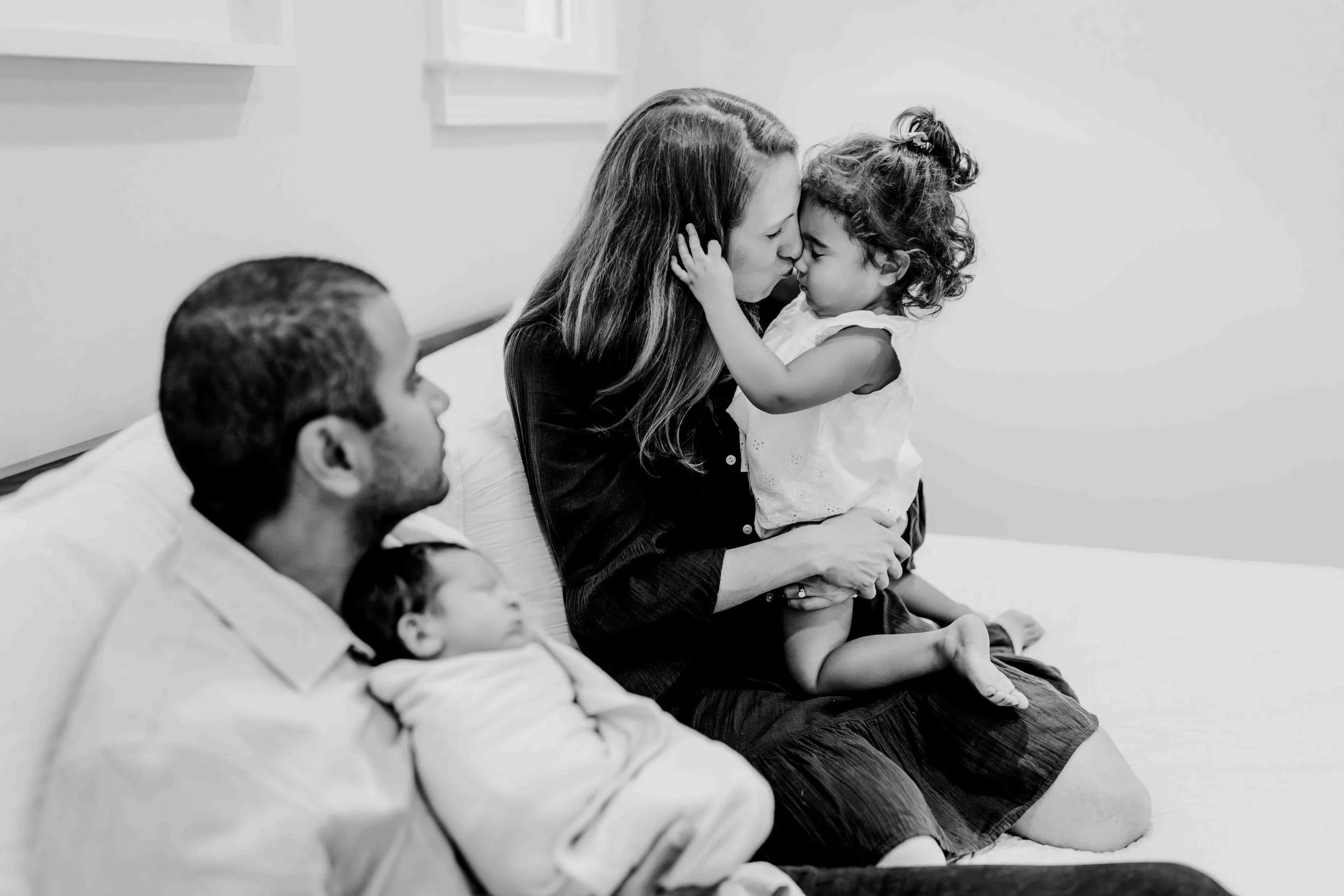 In home newborn photos featuring sibling connection and family cuddles