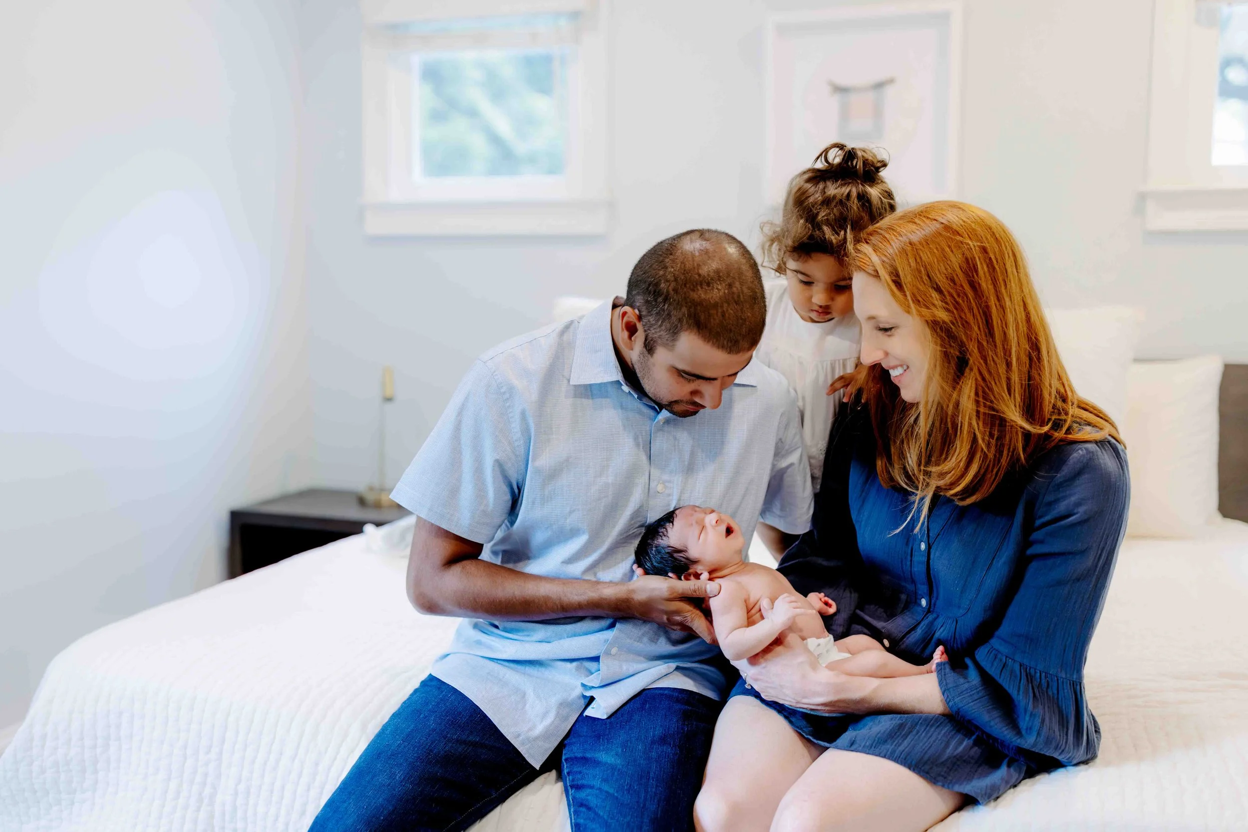 Quiet newborn moment of the family of four captured during in home lifestyle photography