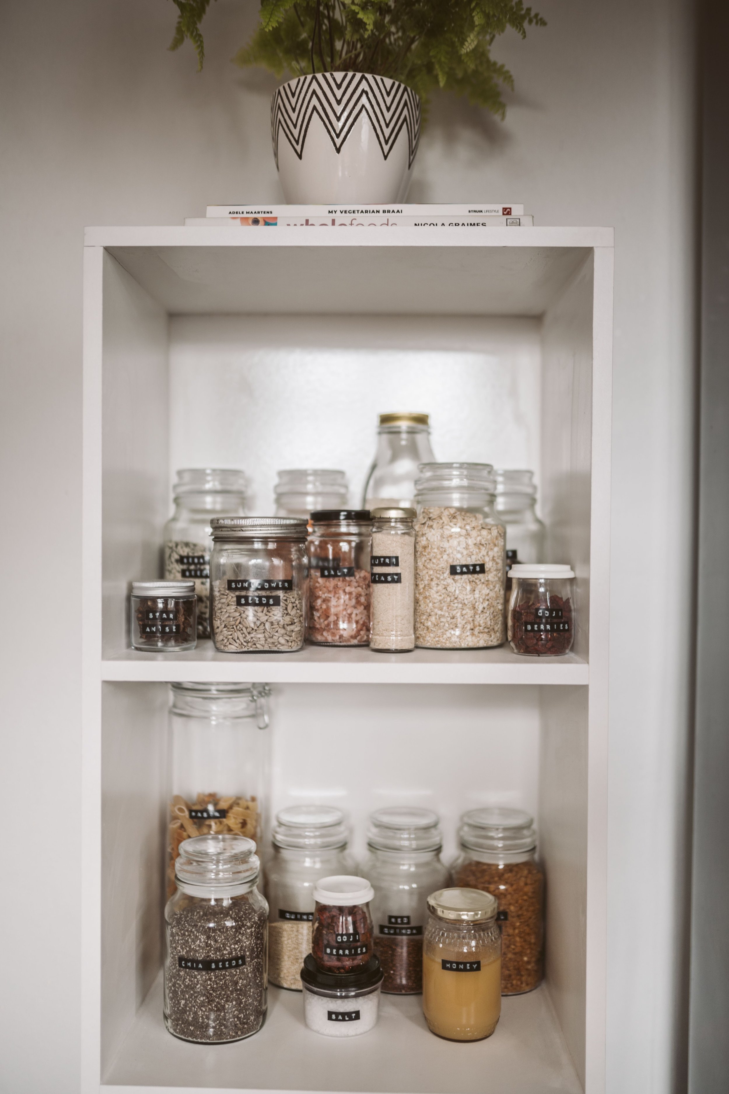 Organized pantry shelves with clearly labeled jars and containers, showing how simple labels can create clarity, reduce overwhelm, and support ADHD-friendly organizing systems.