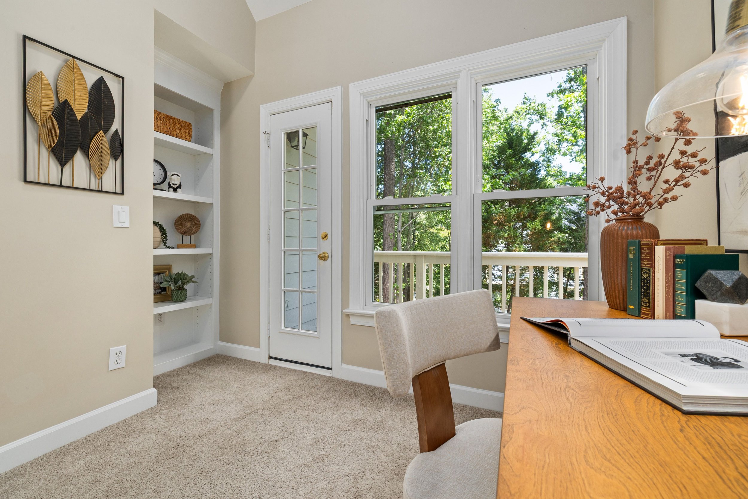 Bright, organized home office with built-in shelves, a tidy desk, and abundant natural light, illustrating how steady organizing progress creates a calm, functional space worth celebrating.