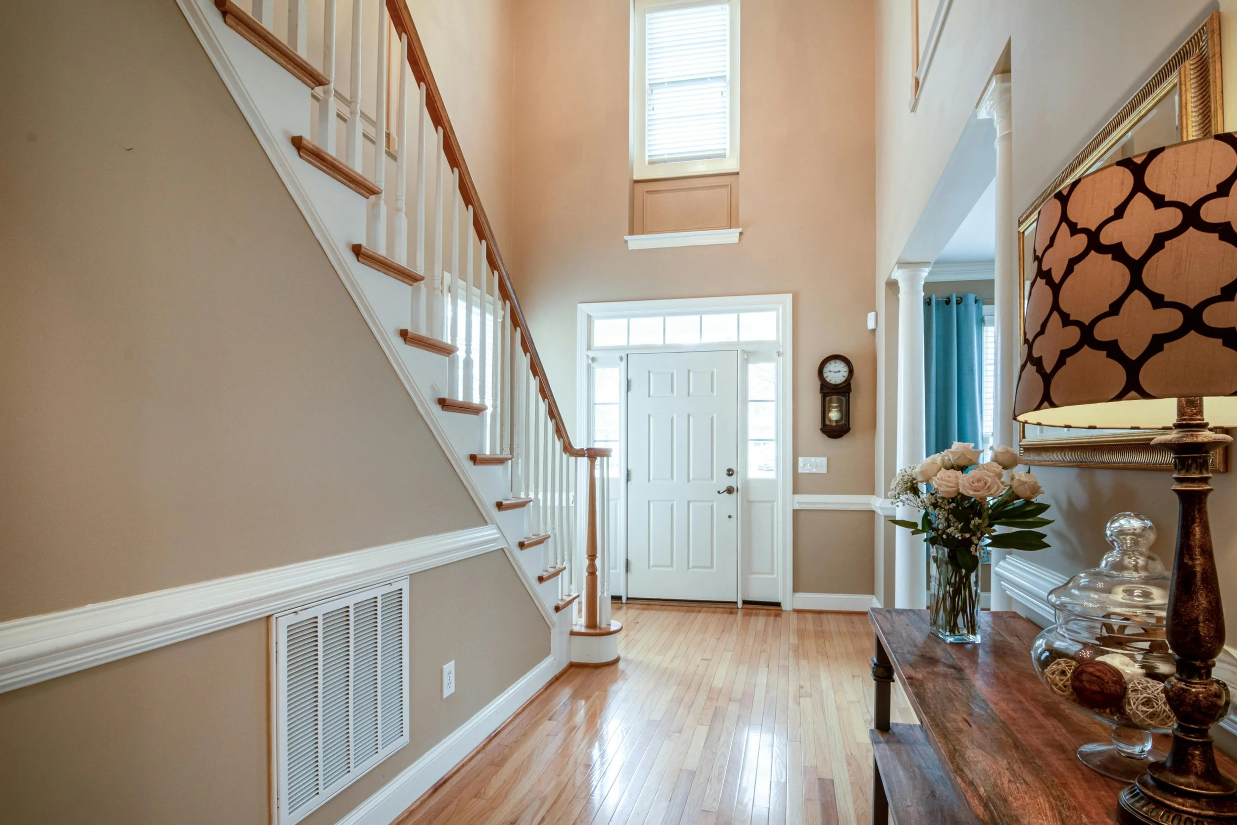 Bright, open entryway with clear walkways and uncluttered surfaces, showing how open space creates calm and momentum in home organizing.