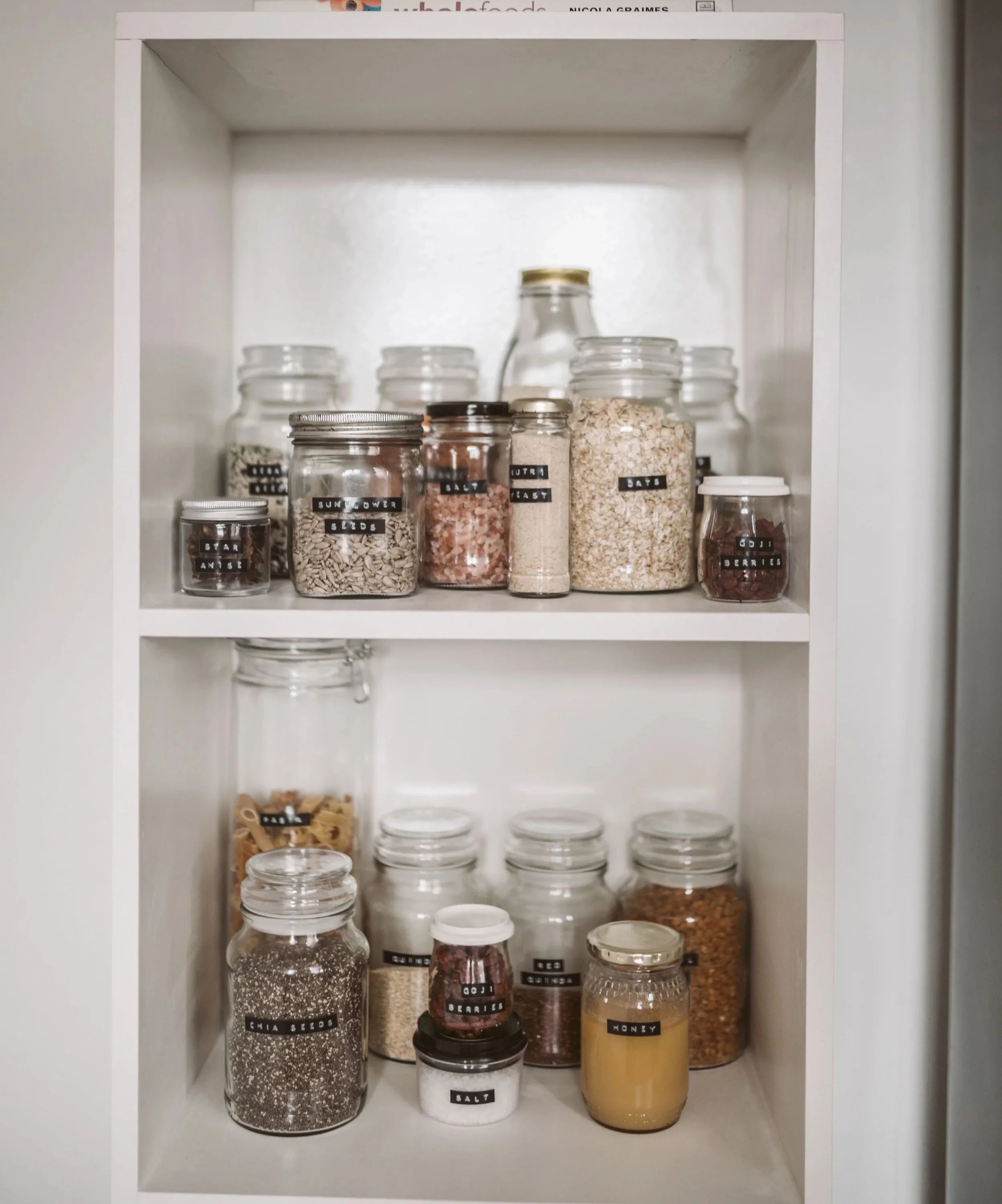 Organized pantry shelves with clearly labeled glass jars for easy everyday access.