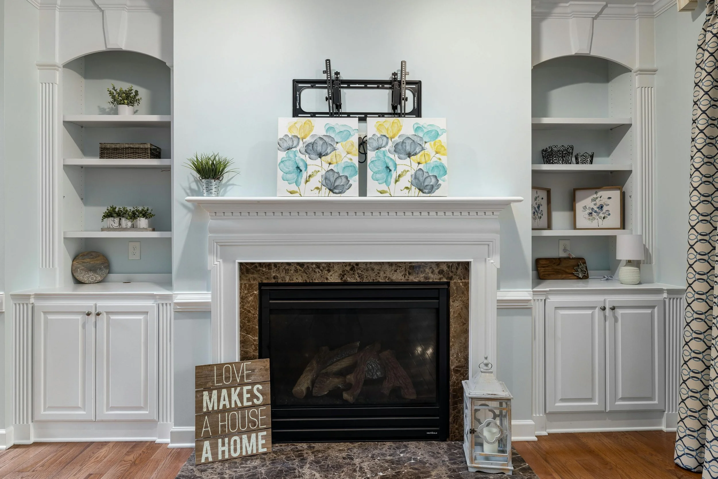 Beautifully organized living room fireplace with balanced built-ins, styled shelves, and open, welcoming space that reflects making room for love and a shared new chapter at home.