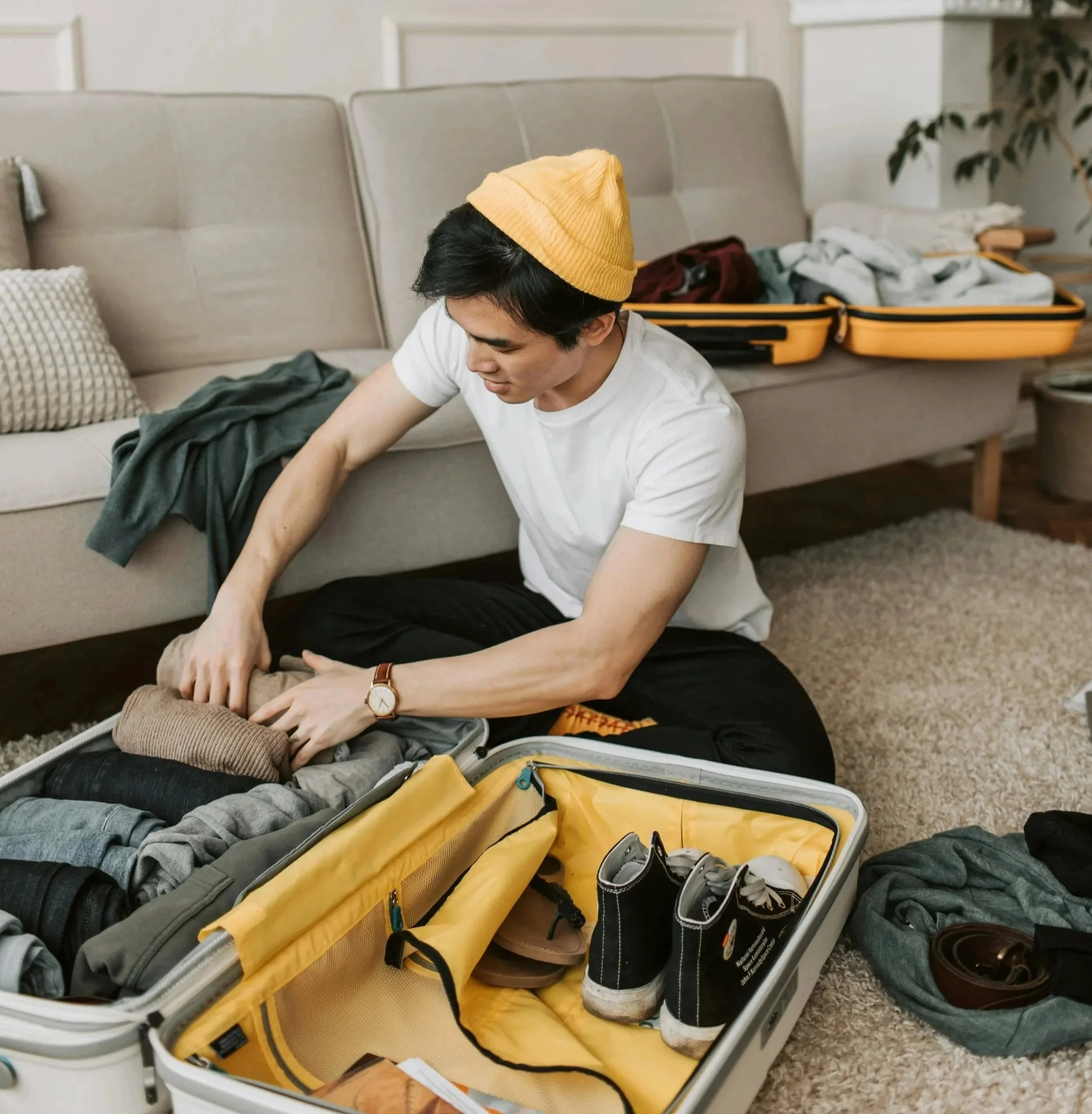 Person calmly packing an organized suitcase at home, showing readiness for spontaneous travel and adventure.