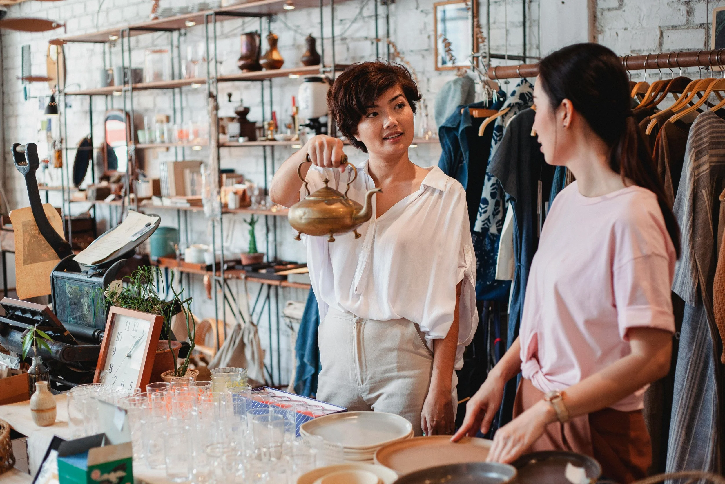 Woman pauses while shopping, thoughtfully considering an item—reflecting the realization that she may already have enough at home.