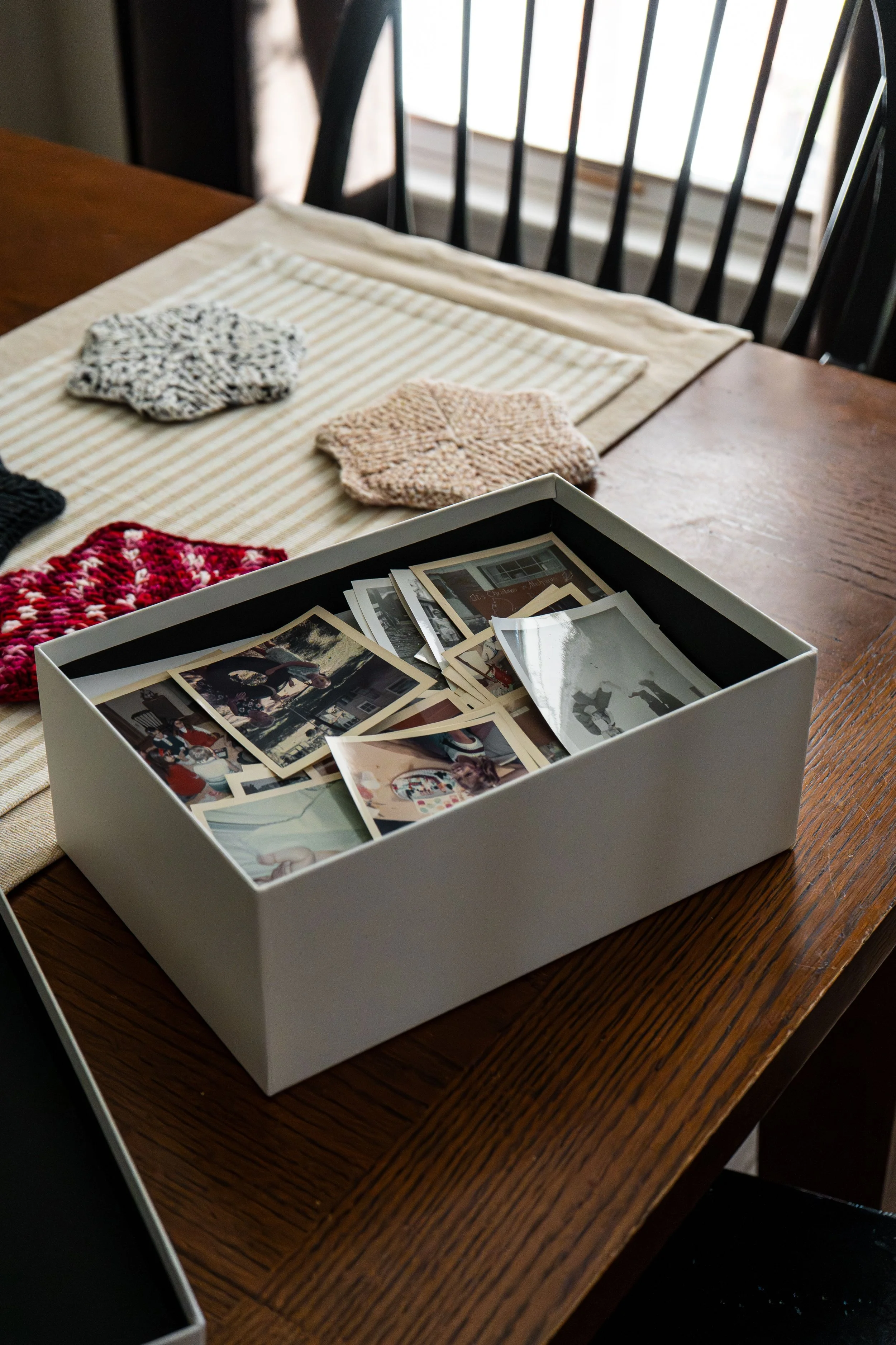 Memory box filled with vintage family photographs, representing the first step in identifying and protecting treasured keepsakes before clearing a loved one's home.