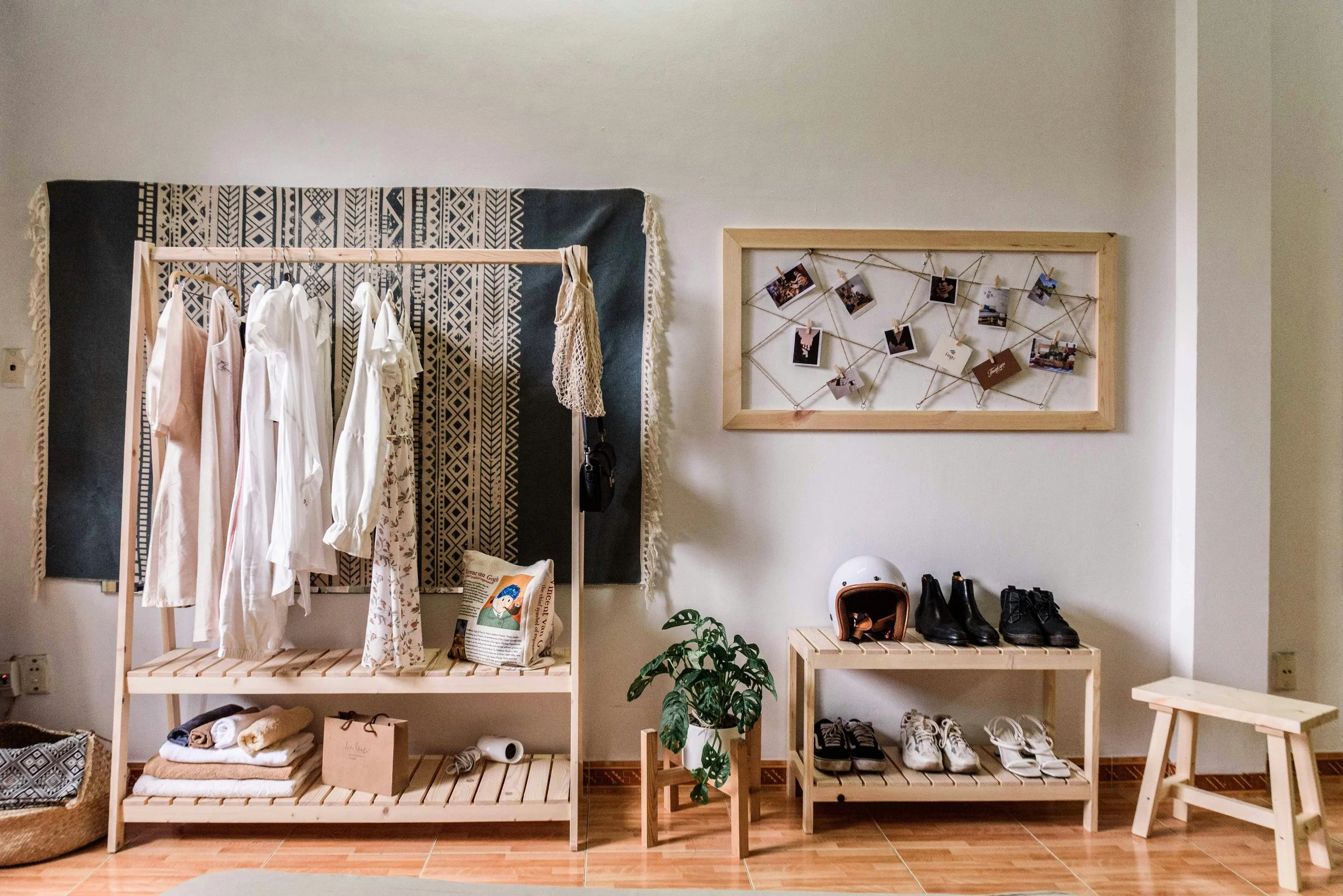 Calm, well-organized space with simple clothing racks and neatly placed shoes, showing how the right placement creates ease, flow, and a home that feels good.