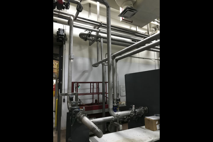 After: The piping helps Coca-Cola's blow mold machines maintain the pressure, hygiene and purity standards required for food-safe bottle production.