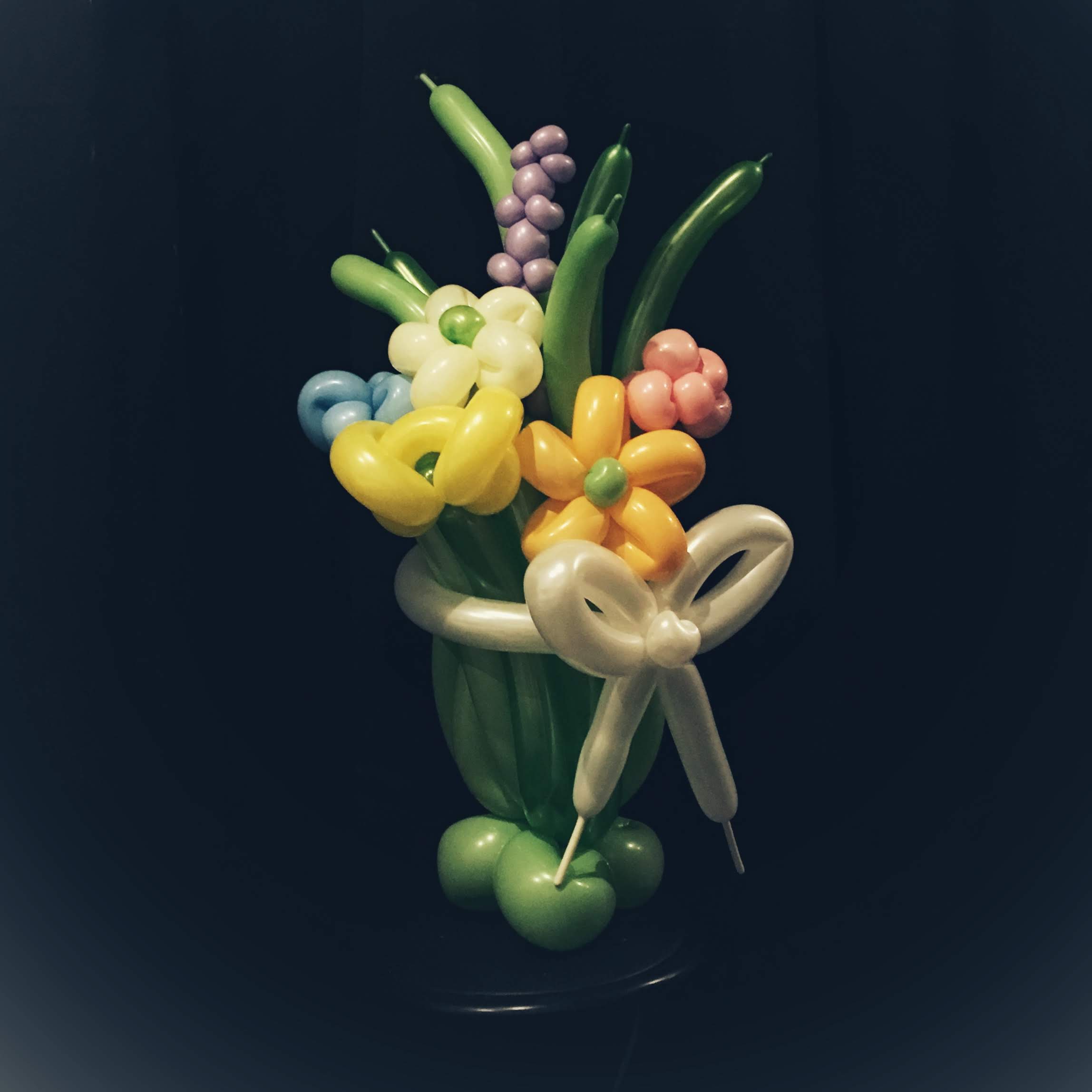 Bouquet. Sweet bouquet with weighted base and bow in pretty palate.jpg