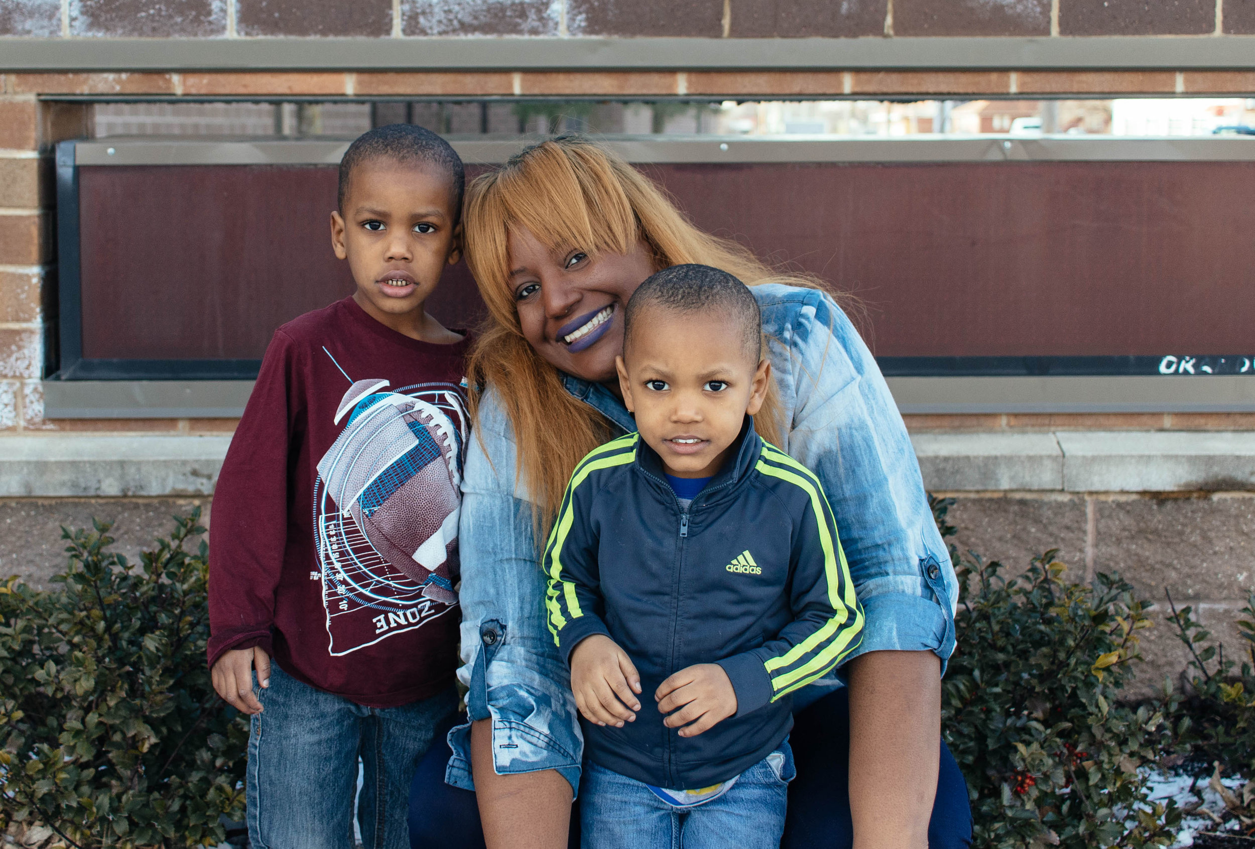  Brenda Ray with her two boys in front of Mason Clark where she attended middle school. Brenda is a power-builder in WEPOWER’s East St. Louis Education Power-Building Academy, a seven-month community-based leadership and policy change program for residents of the area. Photo by Kristen Trudo. 