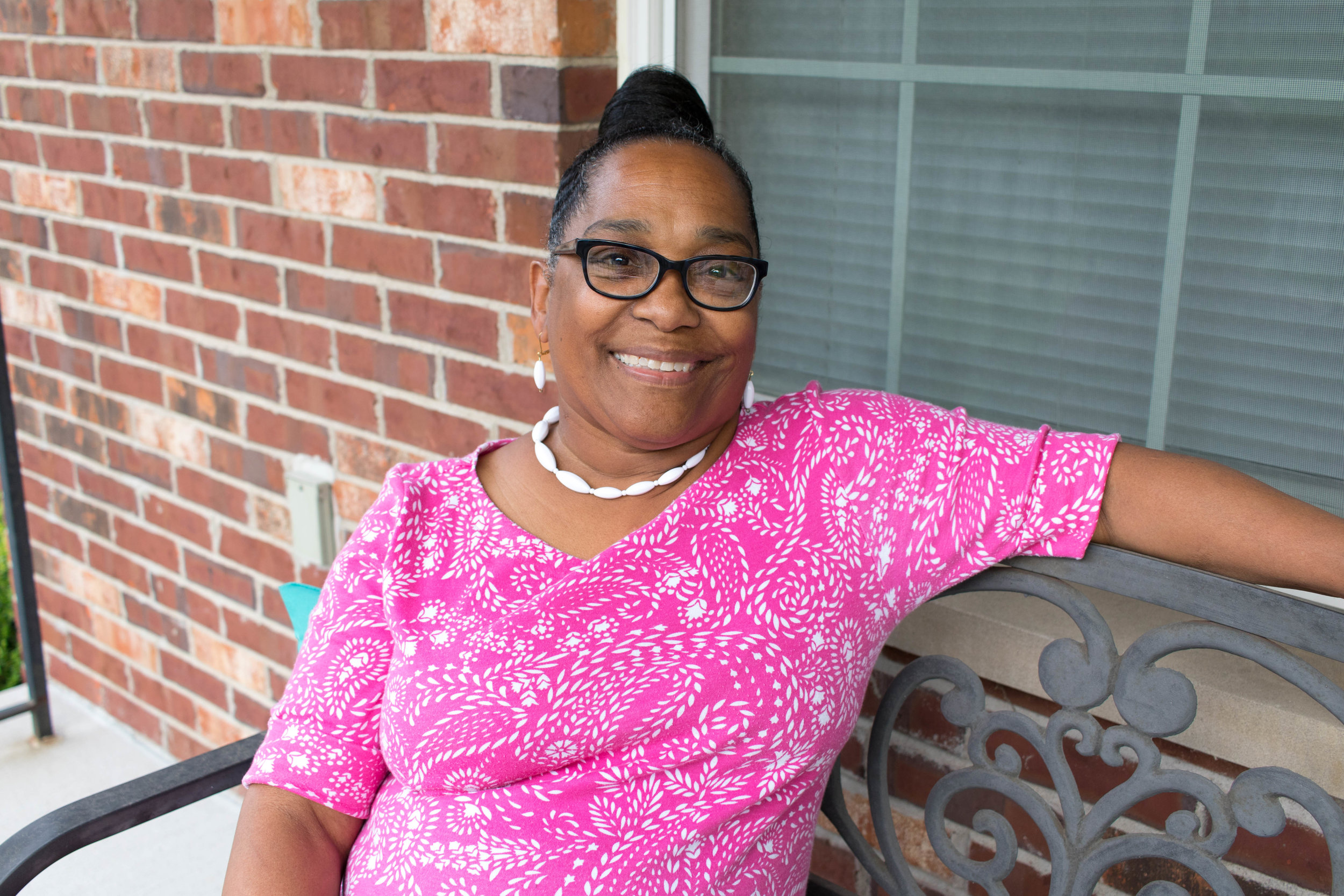  Janet Roberson is a board member of Northside Community Housing and a recent graduate of WEPOWER’s Power-Building Academy. She is pictured here on her front porch in The Ville neighborhood. Photo by Kristen Trudo. 