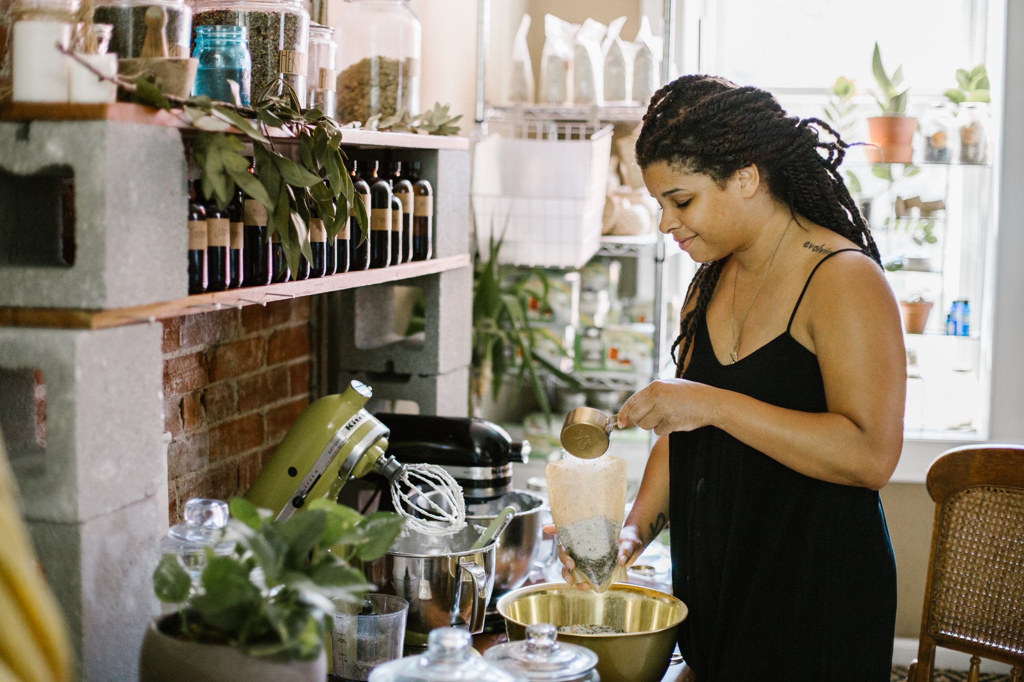   La’Crassia Wilderness, founder of Butter Love by L.C., holds a jar of her handmade body butter. Photo by Abby Gillardi.  