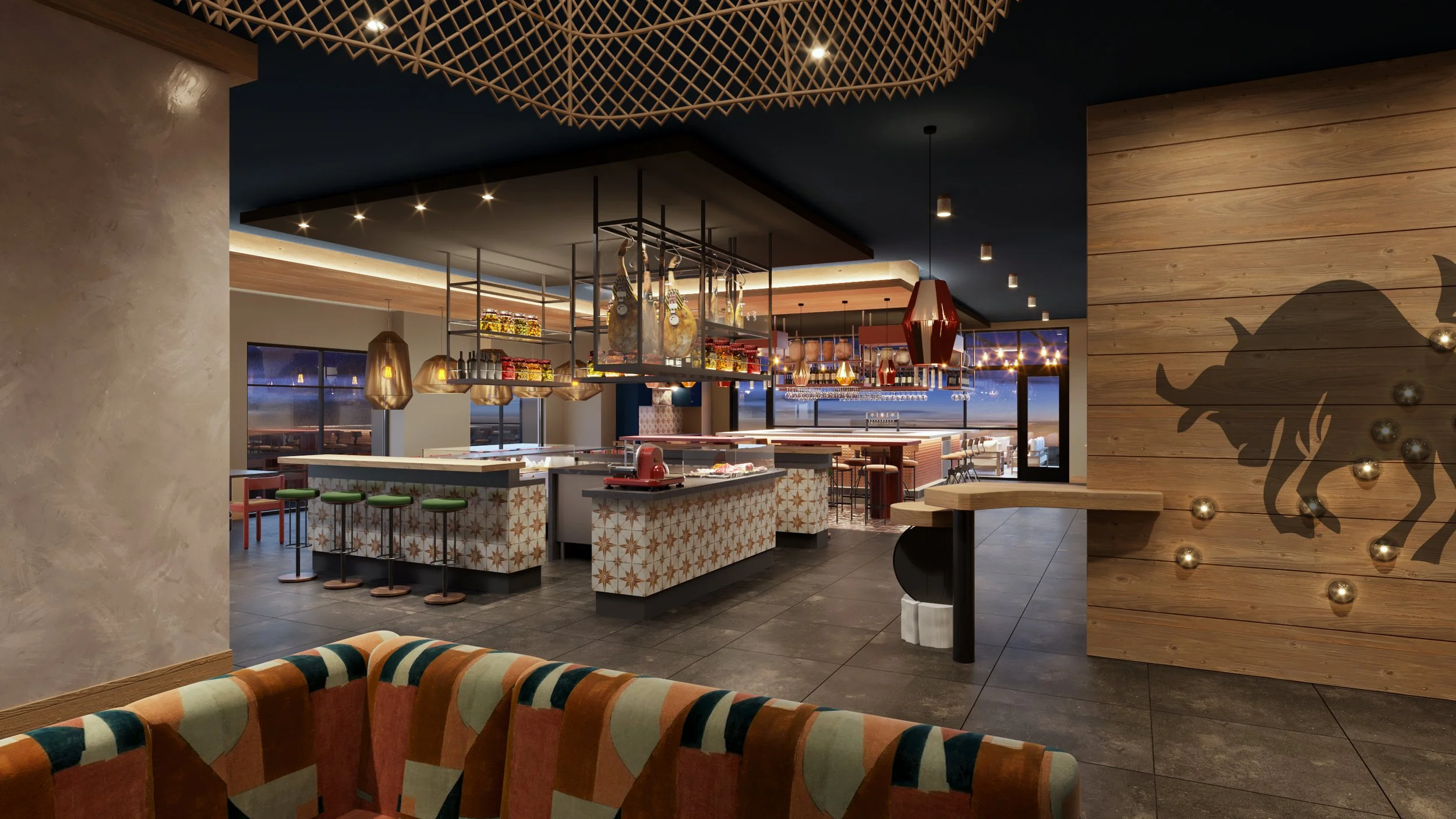 Modern restaurant interior with a dark ceiling, wooden accents, hanging lights, a bar area with hanging cured meats, and a decorative wall featuring a bull silhouette with metallic balls.