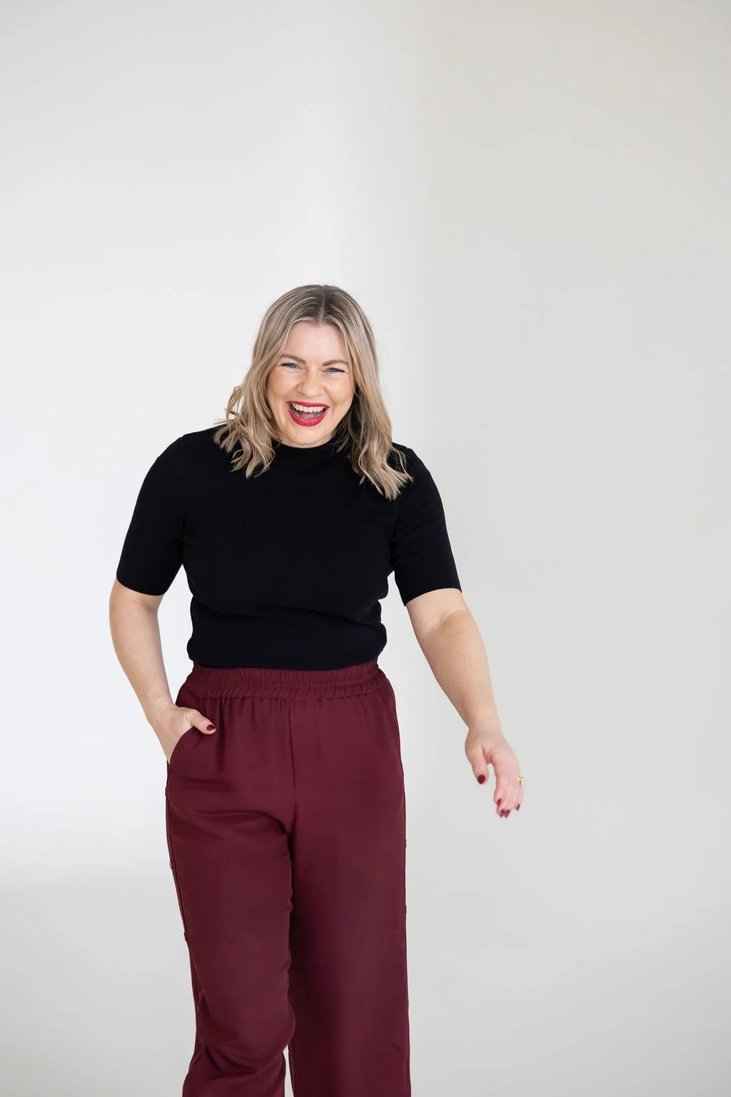 Portrait of Bec Sands, walking towards the camera and smiling