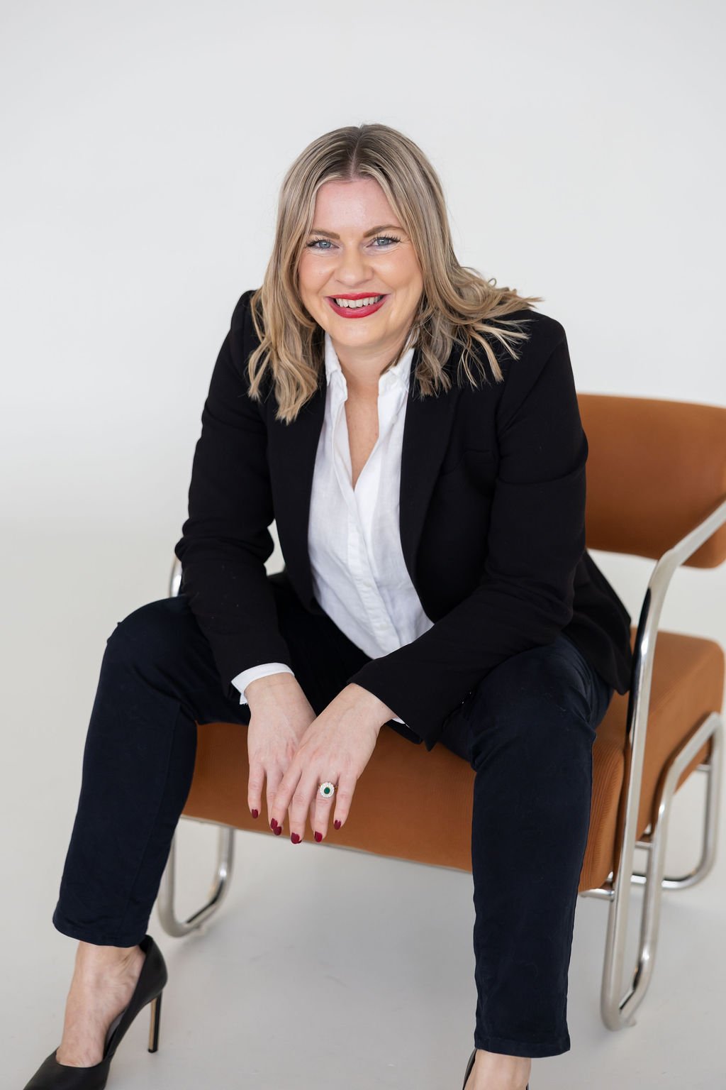 Portrait of Bec Sands, seated on an armchair
