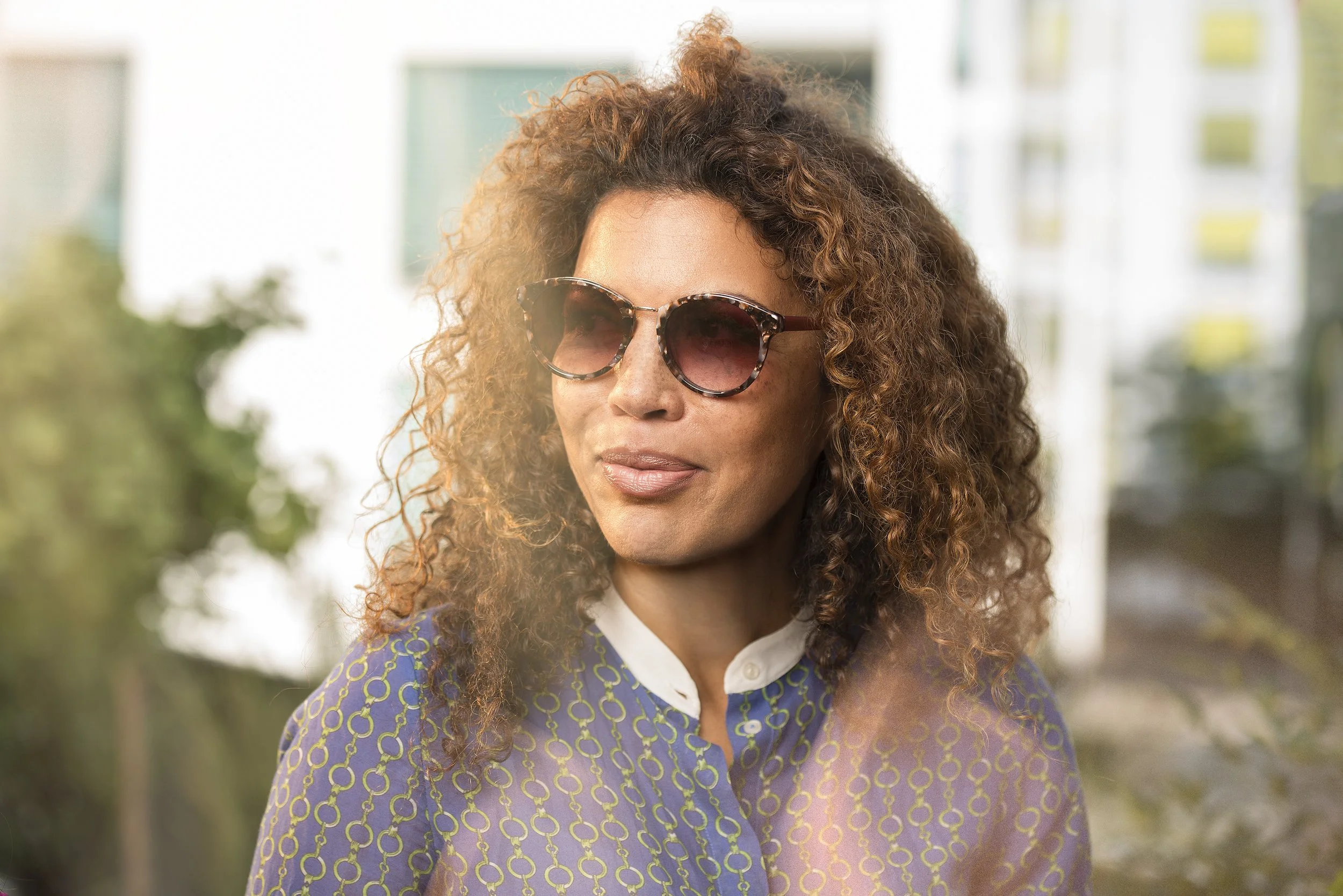 Frau auf Terrasse mit Sonnenbrille