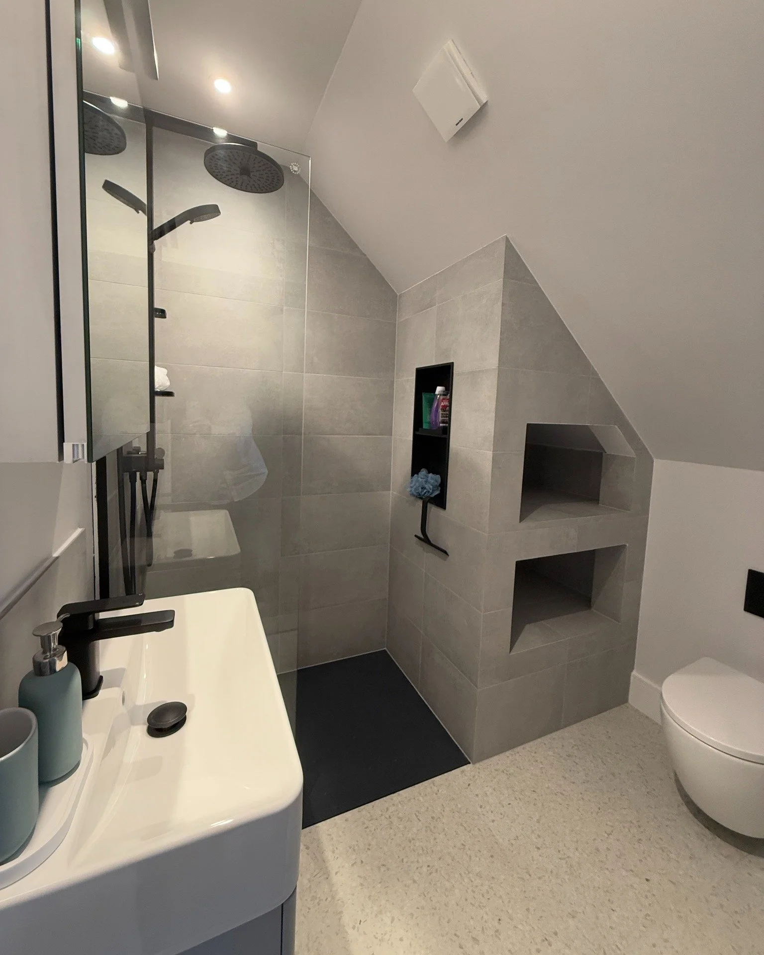 The smaller the space, the more thought that needs to go into maximising it to create a usable yet functional bathroom. This one, tucked under the eaves, was particularly tricky. By using the “dead” space at the end of the shower, I was a