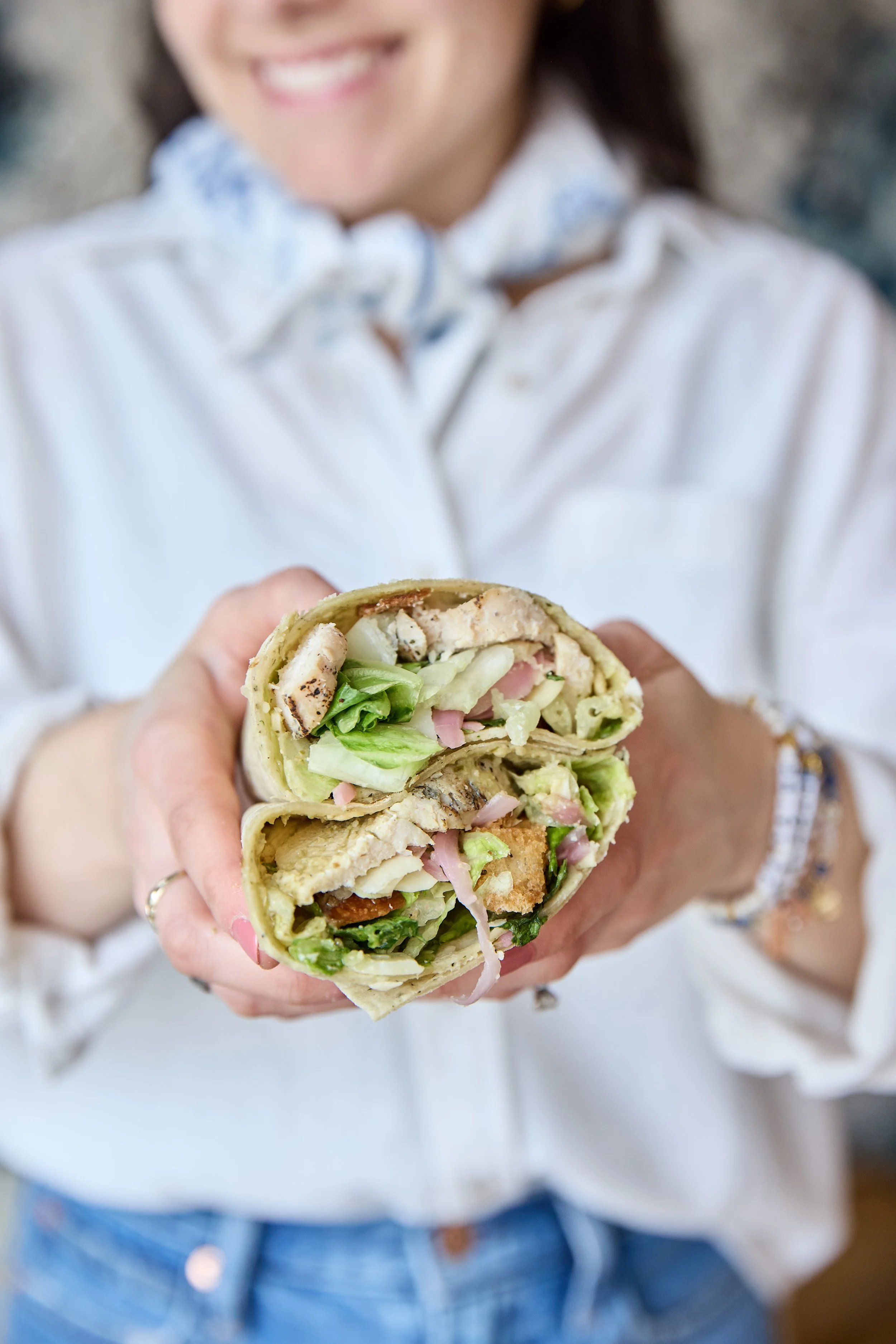 marie's chicken caesar wrap in hand 1.jpg