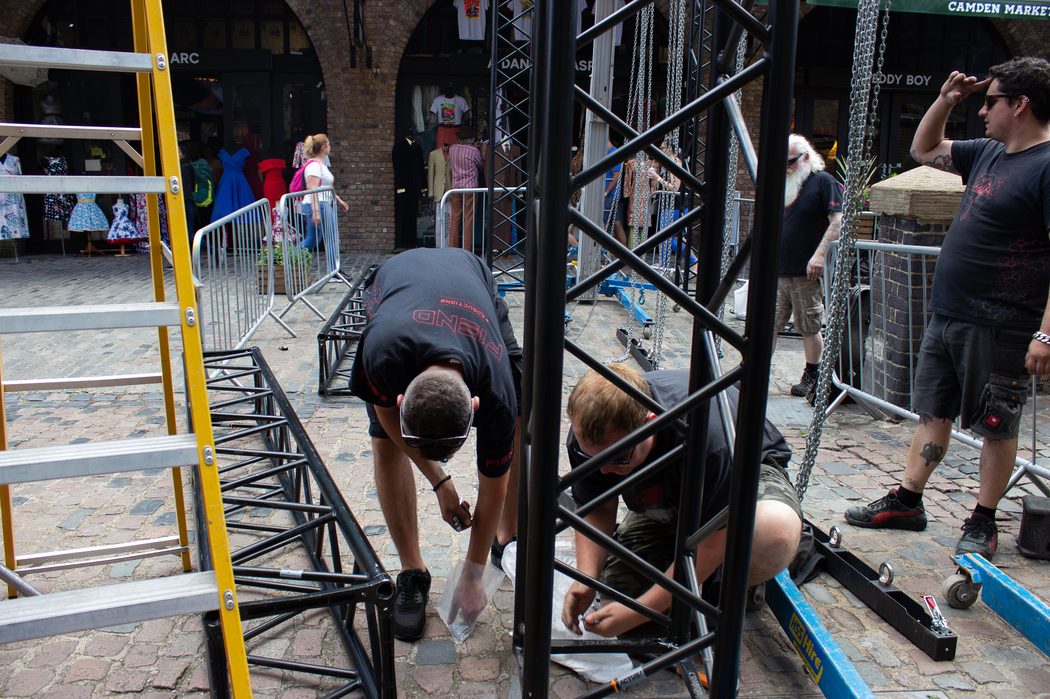 men working on bases of truss