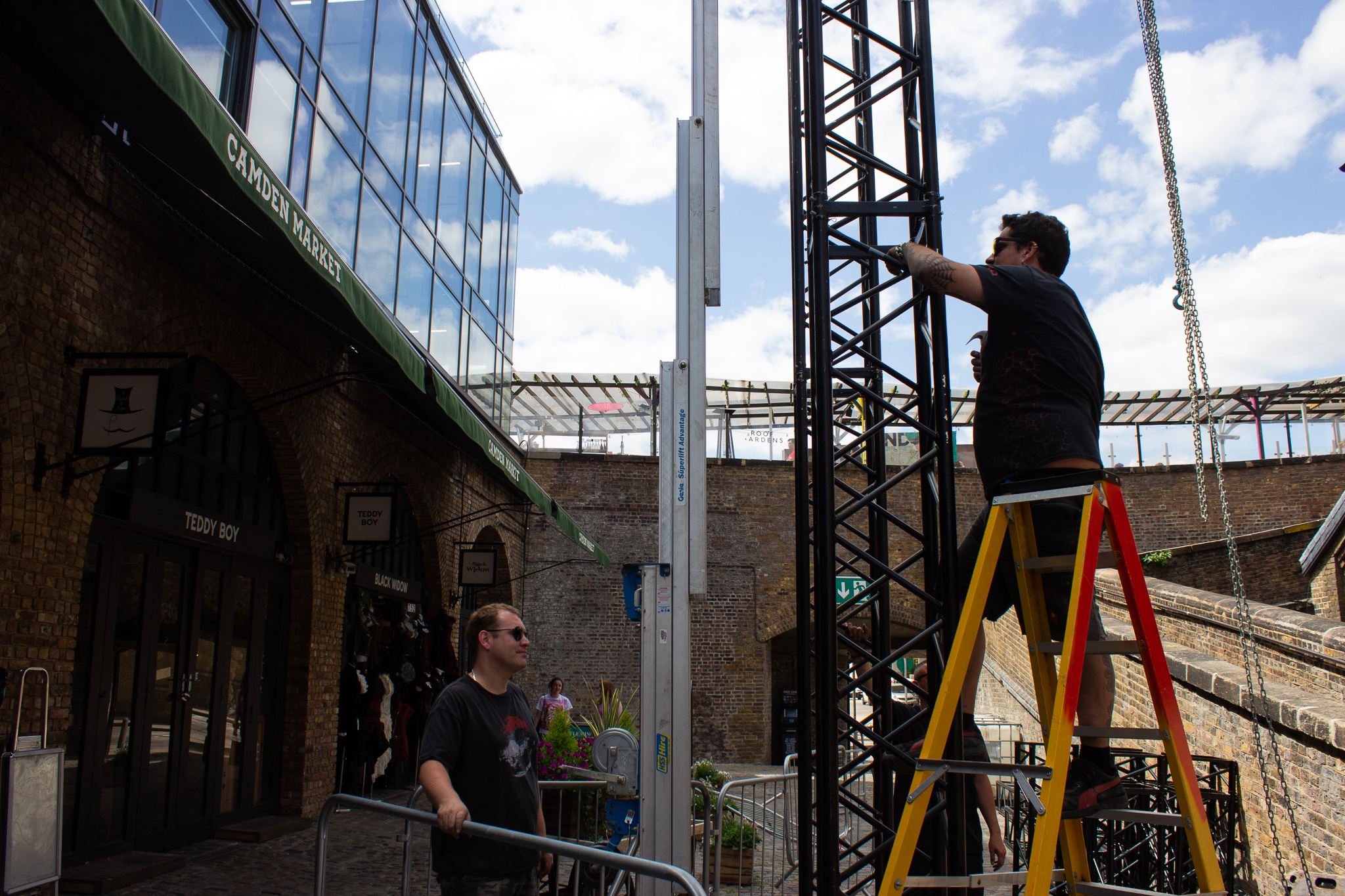 man climbing truss