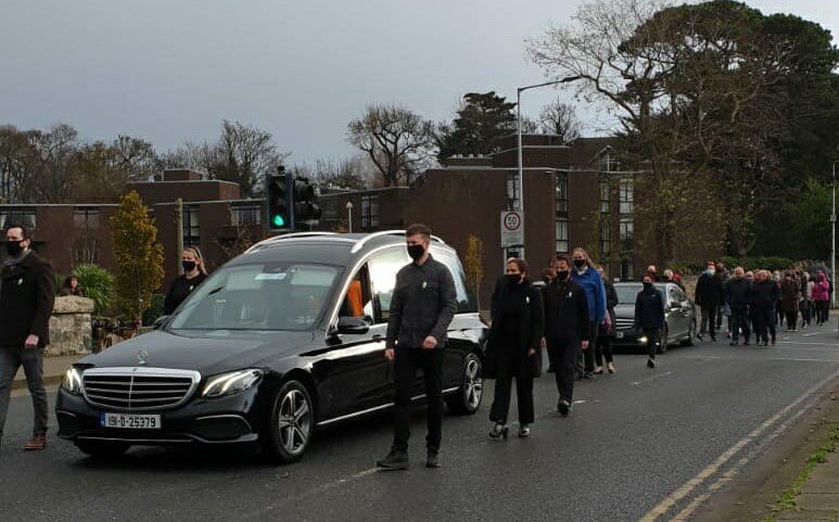 The hearse bearing the tri-colour draped coffin of Donal Ó Sé, flanked by a republican guard of honour, making the journey from Donal’s home to Milltown Church.