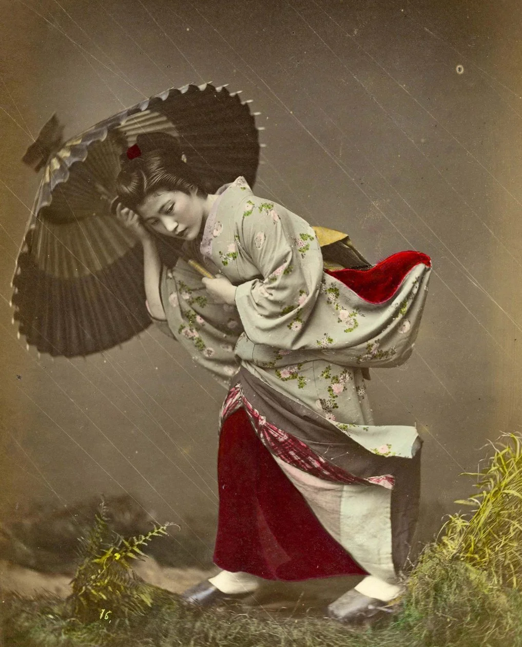 Kusakabe Kimbei Woman caught in a rain storm c1890