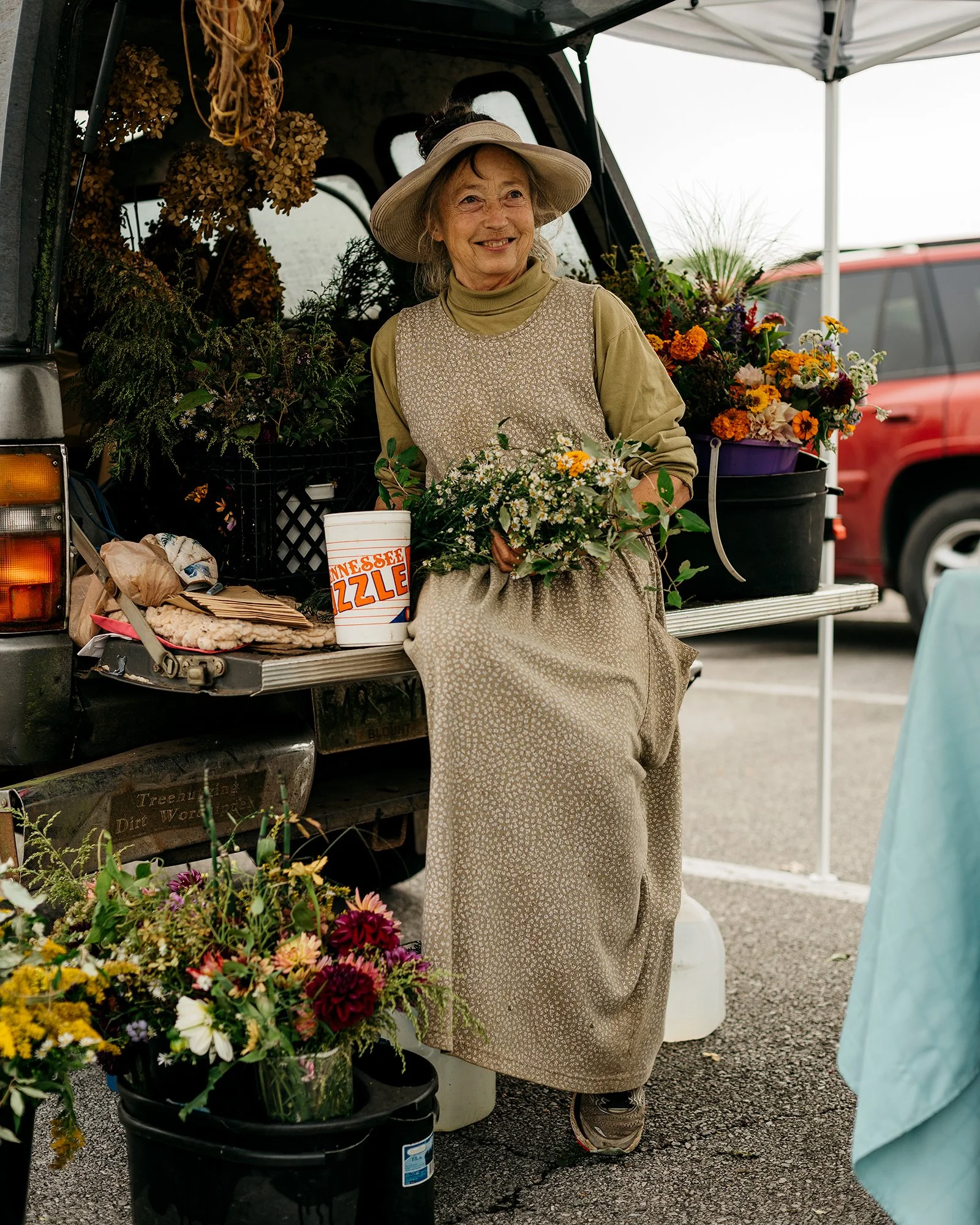 A woman selling flowers at a farmer's market in east Tennessee