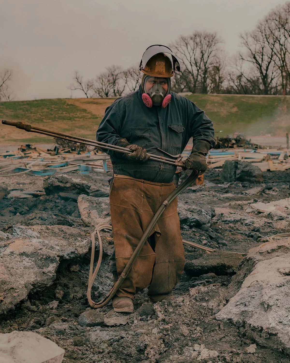A portrait of a man standing in a steel scrap yard at Big River Steel in Osceola, Arkansas