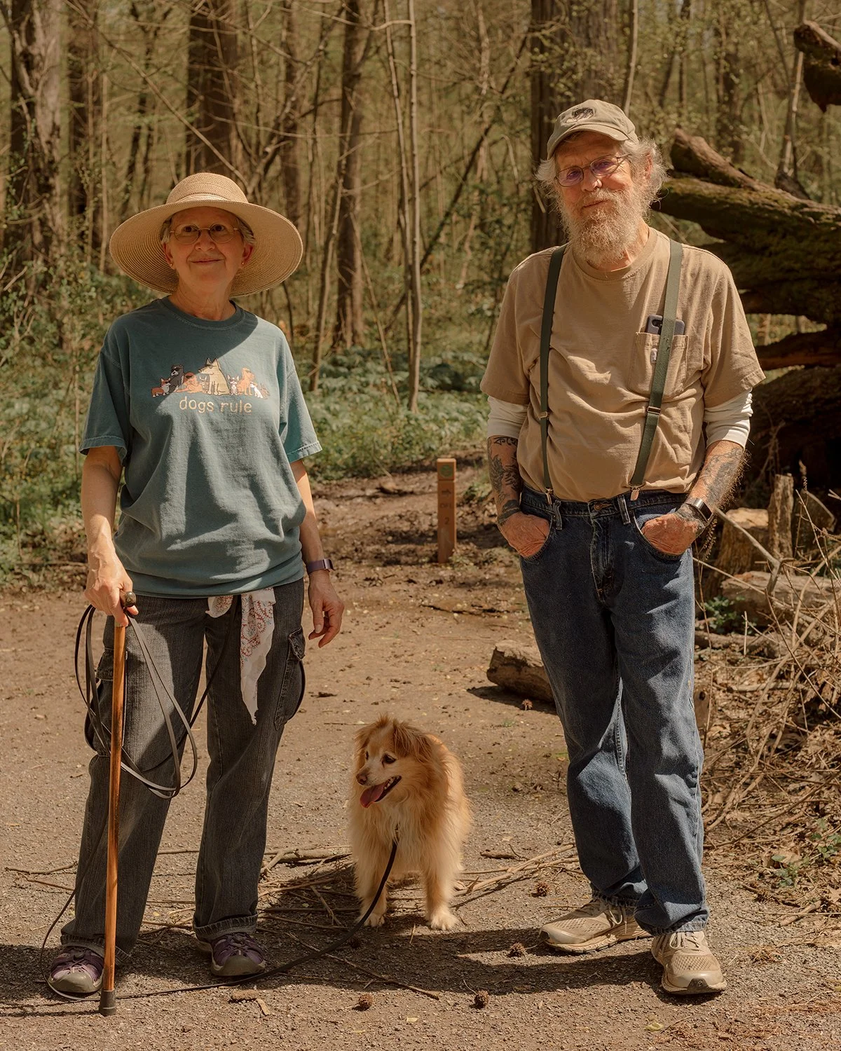 An elderly couple walks their dog in Overton Park in Memphis, Tennessee