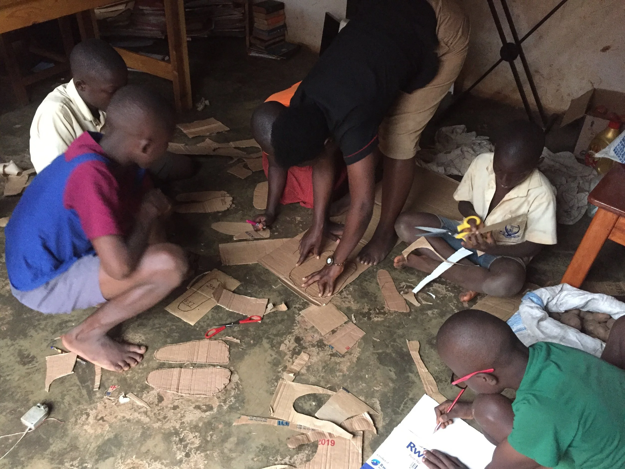 Nawaguma Irene during a shoe making session  with chikdren.jpeg