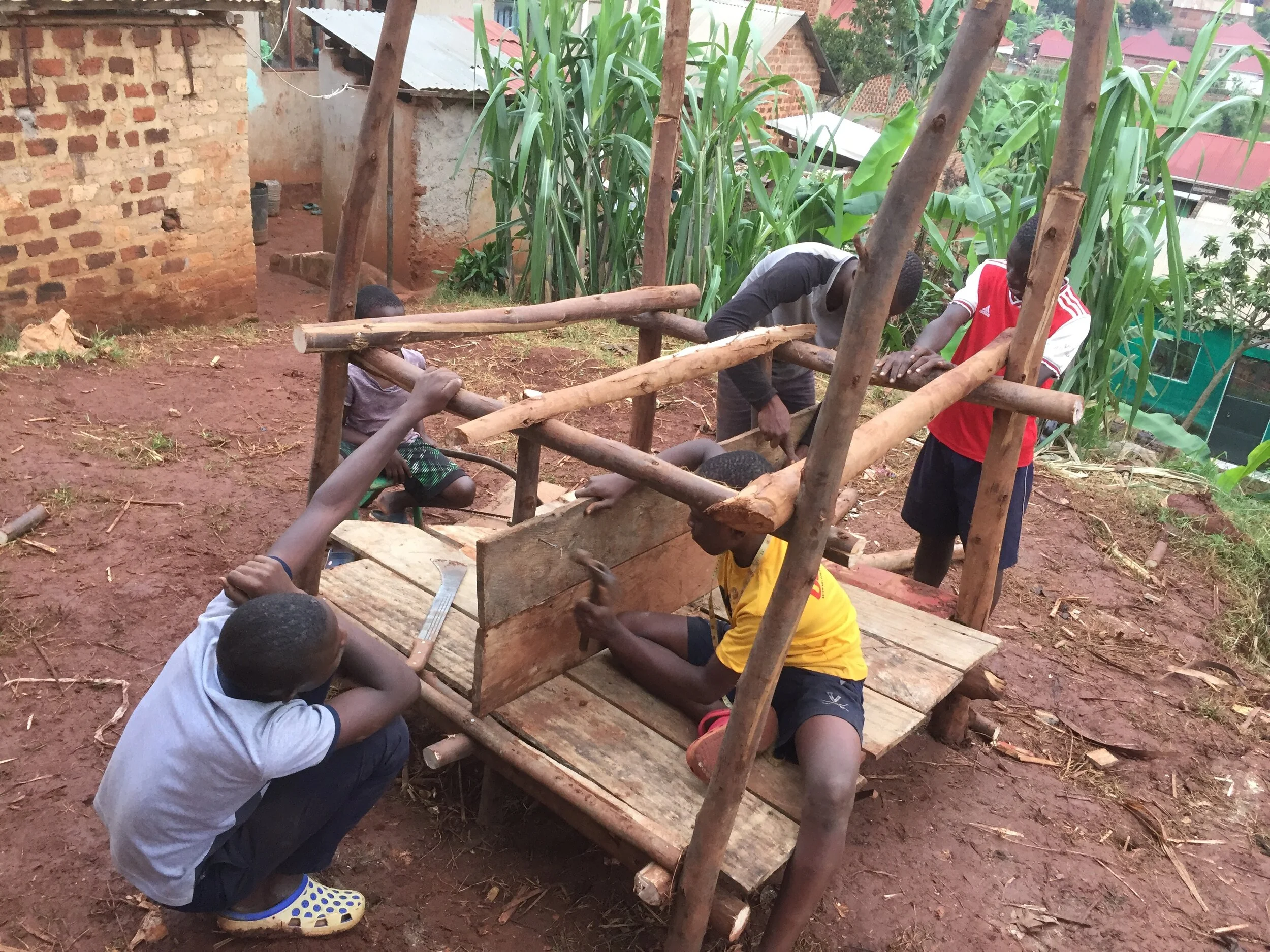 Boys making a rabbit and chicken cage.JPG