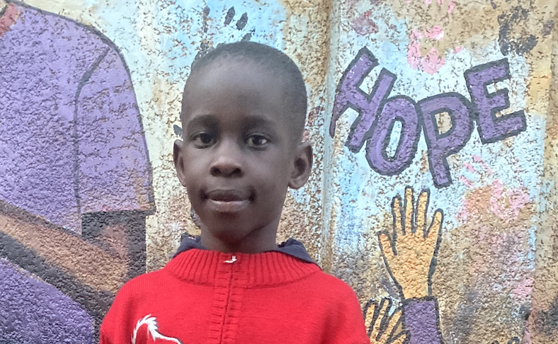 boy in red sweater at Peter's Heart Center