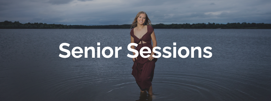 high school senior girl in lake wearing red dress at dusk