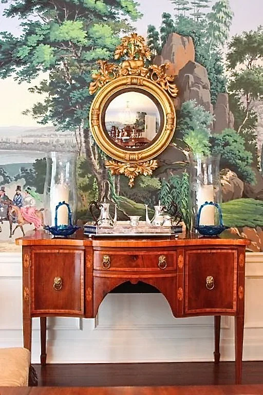 A Sheraton sideboard against Zuber wallpaper. Note the veneers and inlays, plus the lions head hardware.