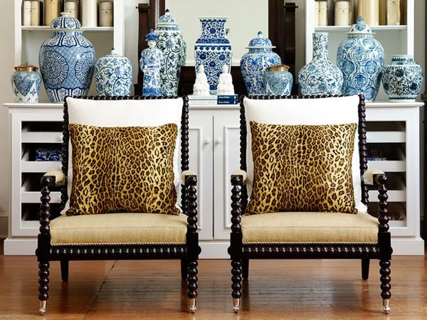 Bobbin chairs remain very popular and these look terrific with the leopard pillows and accessorized with all those blue and white ceramics.