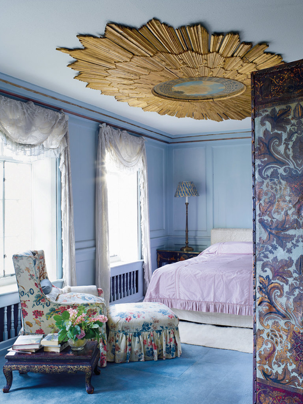 A Baroque frame on the ceiling of a bedroom in Victoria Press’s London townhouse, with a contemporary painting in the Baroque style by Wally Carvell in the center.