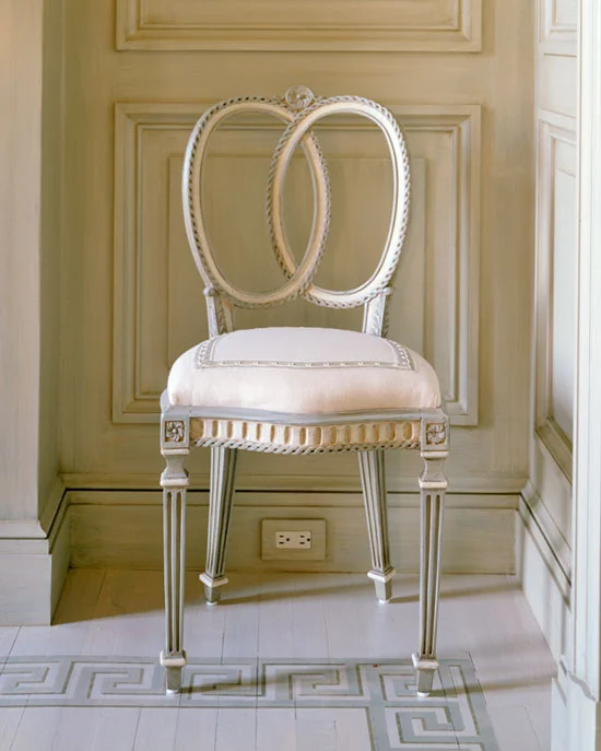 On the corner blocks on the legs of this chair.