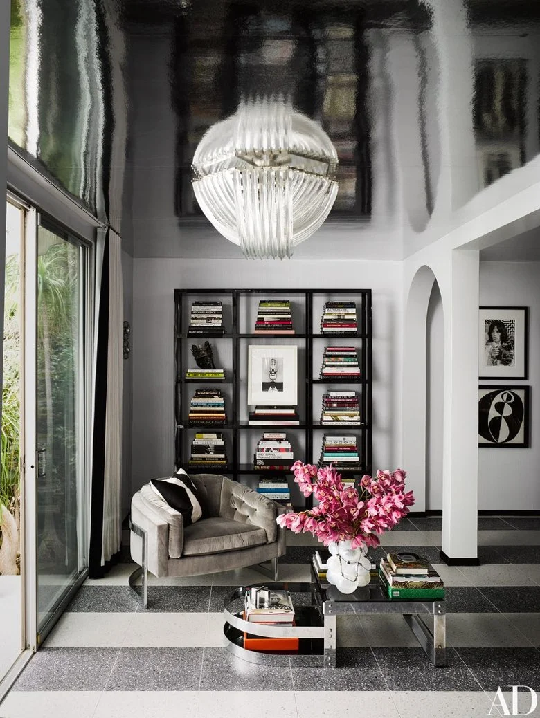 Martyn Lawrence Bullard's home in Palm Springs. The master suite’s sitting room boasts a Karl Springer bookcase, a Willy Rizzo cocktail table, and a vintage Milo Baughman lounge chair covered in Loro Piana Interiors silk.