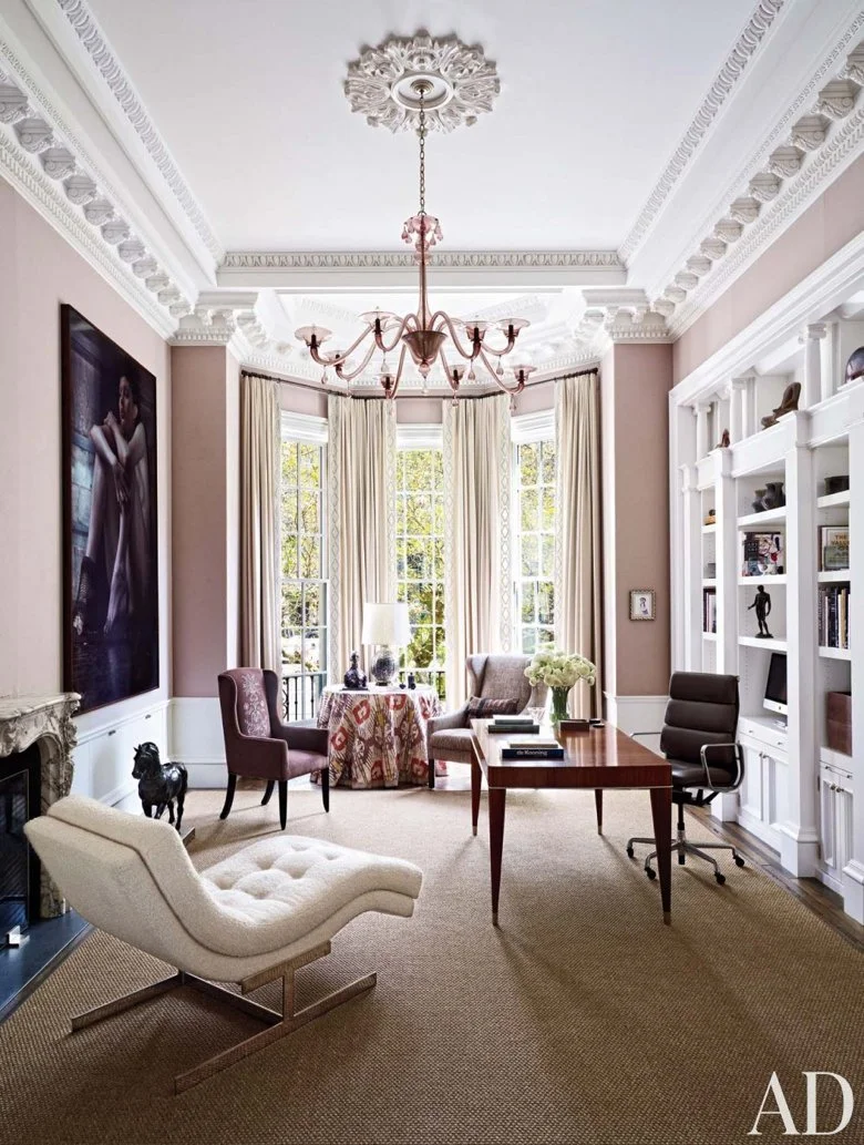 A Martin Eder photograph presides over the study in a Boston townhouse; the 1930s Venini chandelier is from Doris Leslie Blau, the vintage chaise longue is a Milo Baughman design for Thayer Coggin, and the leather-bound sisal is by Stark.
