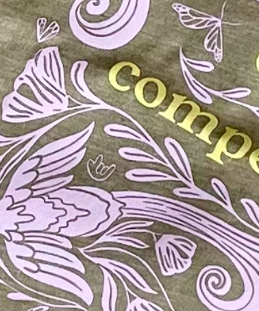 a close up of the back of the shirt showing the ILY handshape.