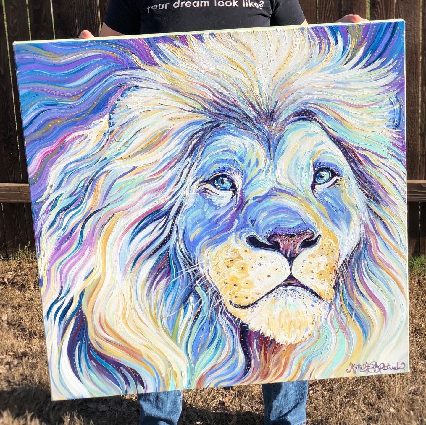 A close up of the white Lion painting in Kate’s hands.