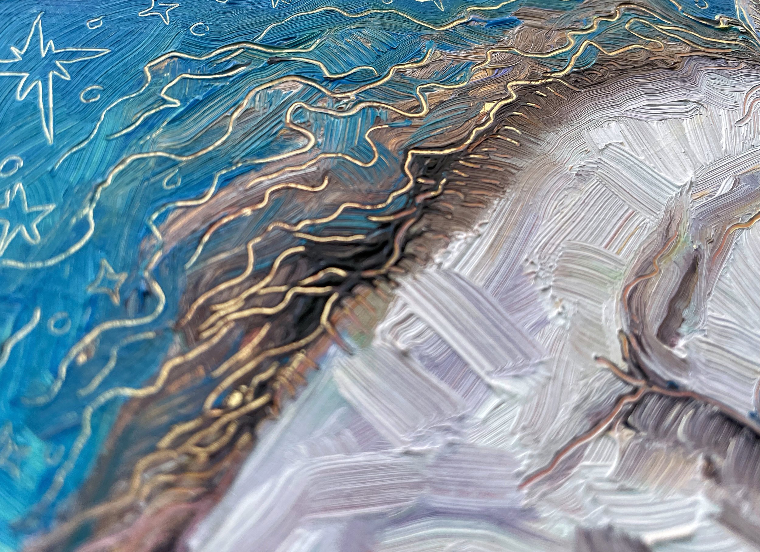 a close up on texture and carving in the painting that reveals gold leaf underneath