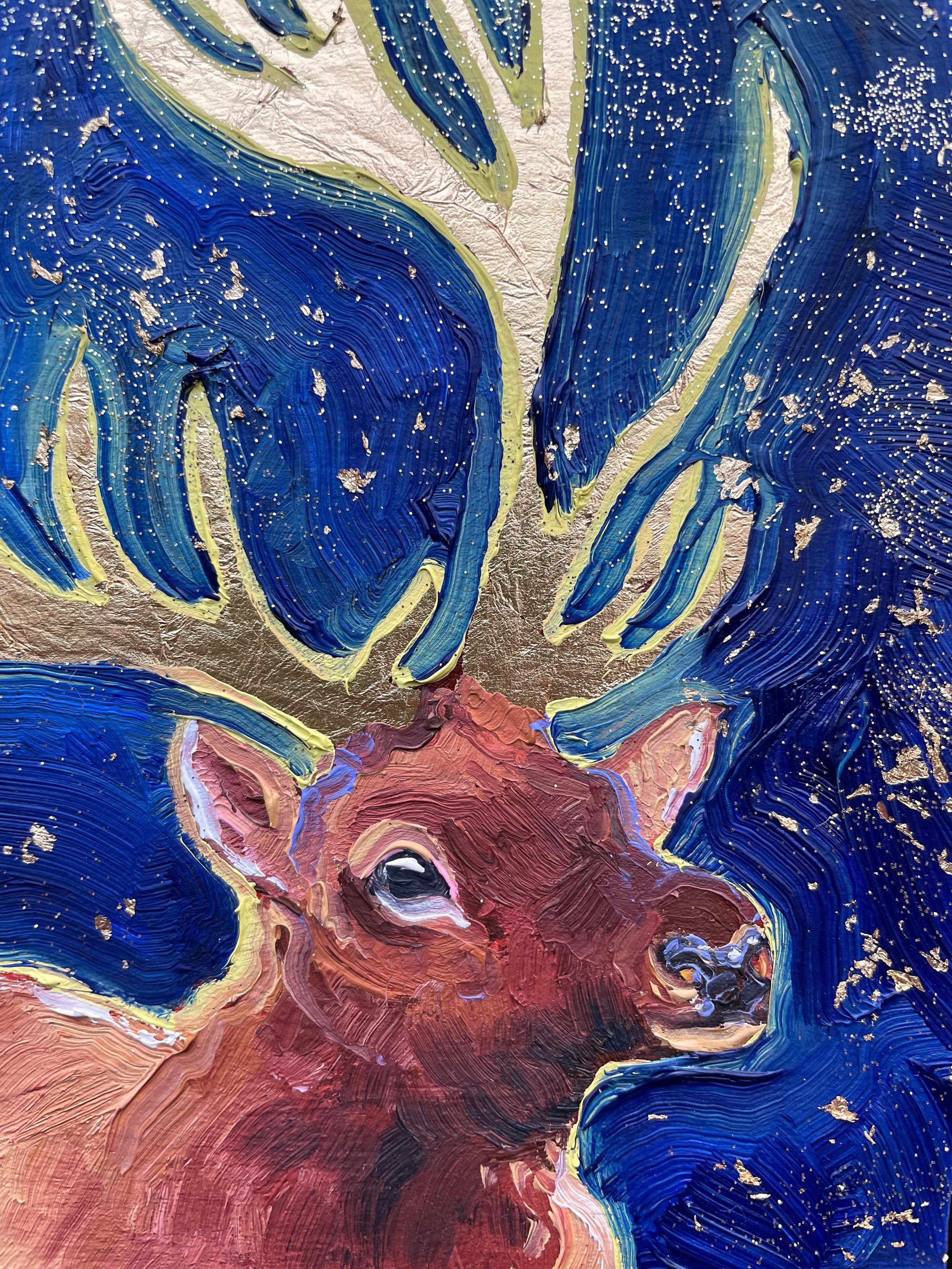 a close up on the painting of the elk with gold leaf antlers