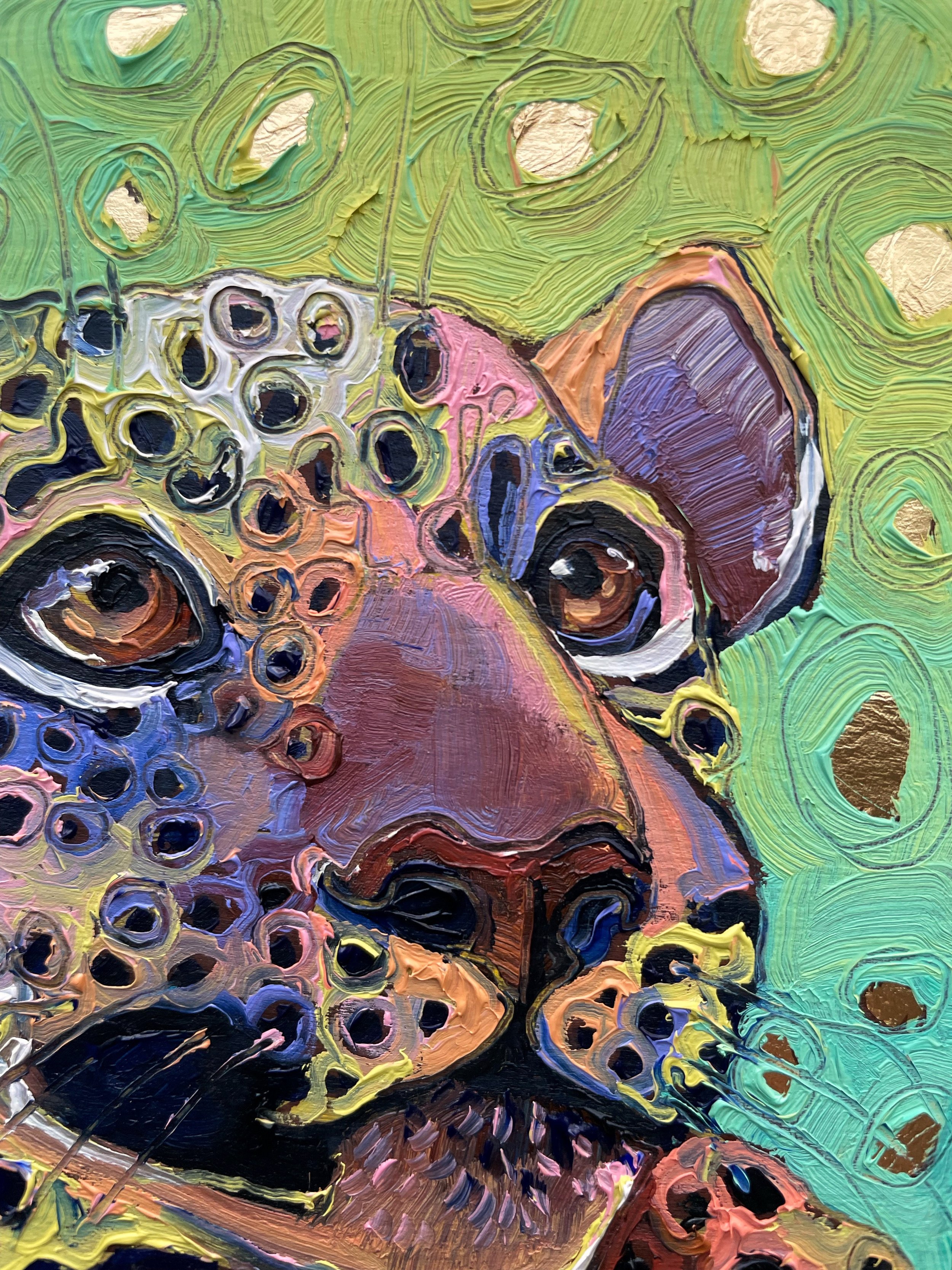 a close up on the eyes and paint texture of the baby leopard painting