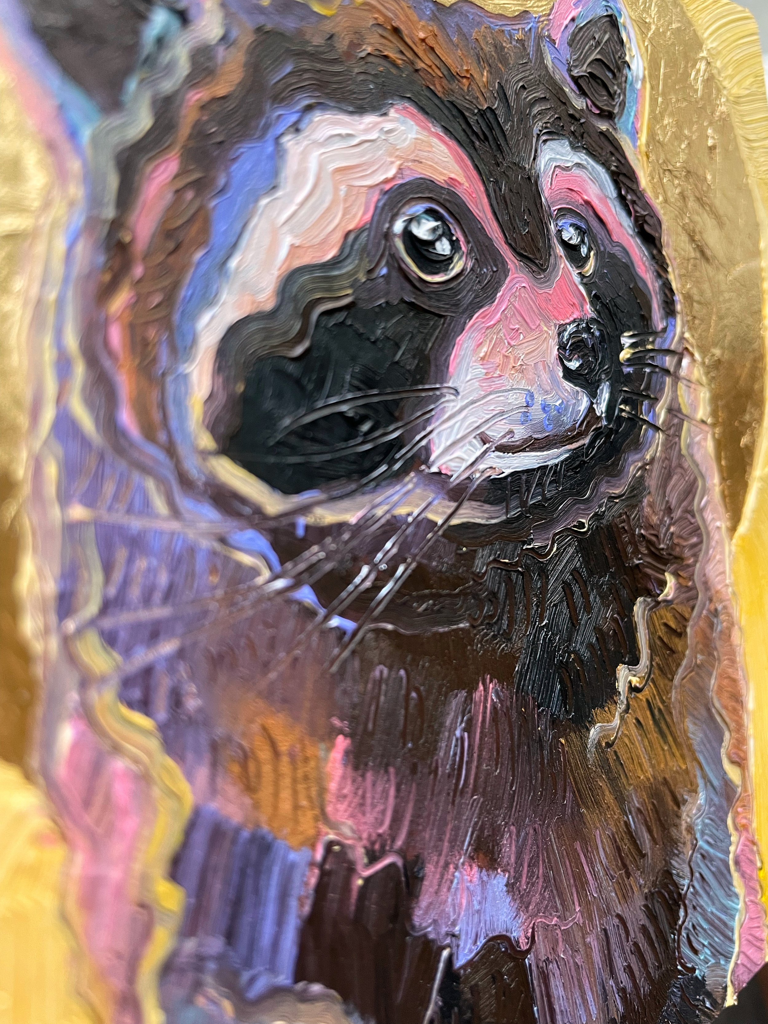 a close up on the paint texture of the cute raccoon painting