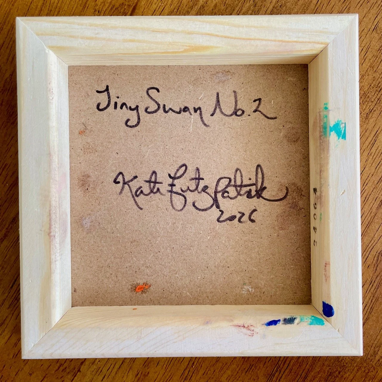 the back of the swan painting with writing that reads Tiny Swan No 2 Kate Fitzpatrick 2026