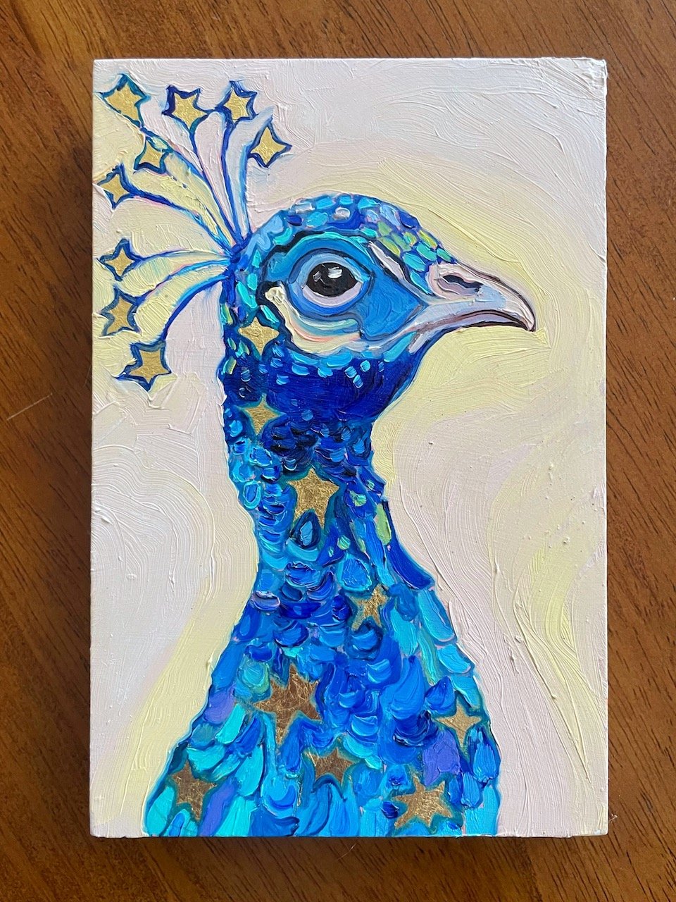 a painting of a blue peacock with stars in its feathers