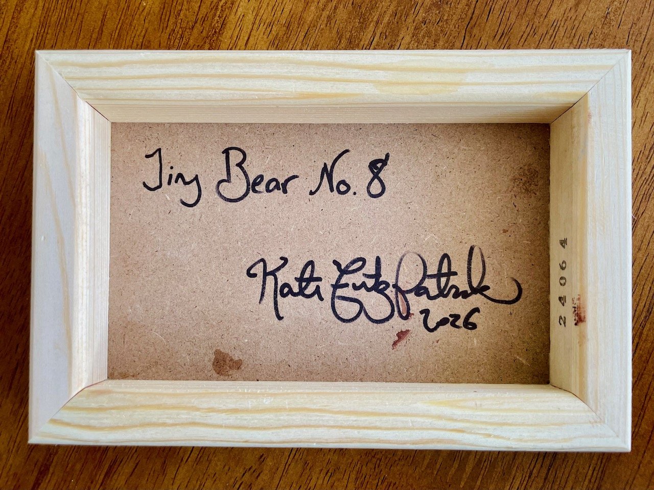 the back of the cradled wood canvas with writing that says tiny bear no.8 kate fitzpatrick 2026