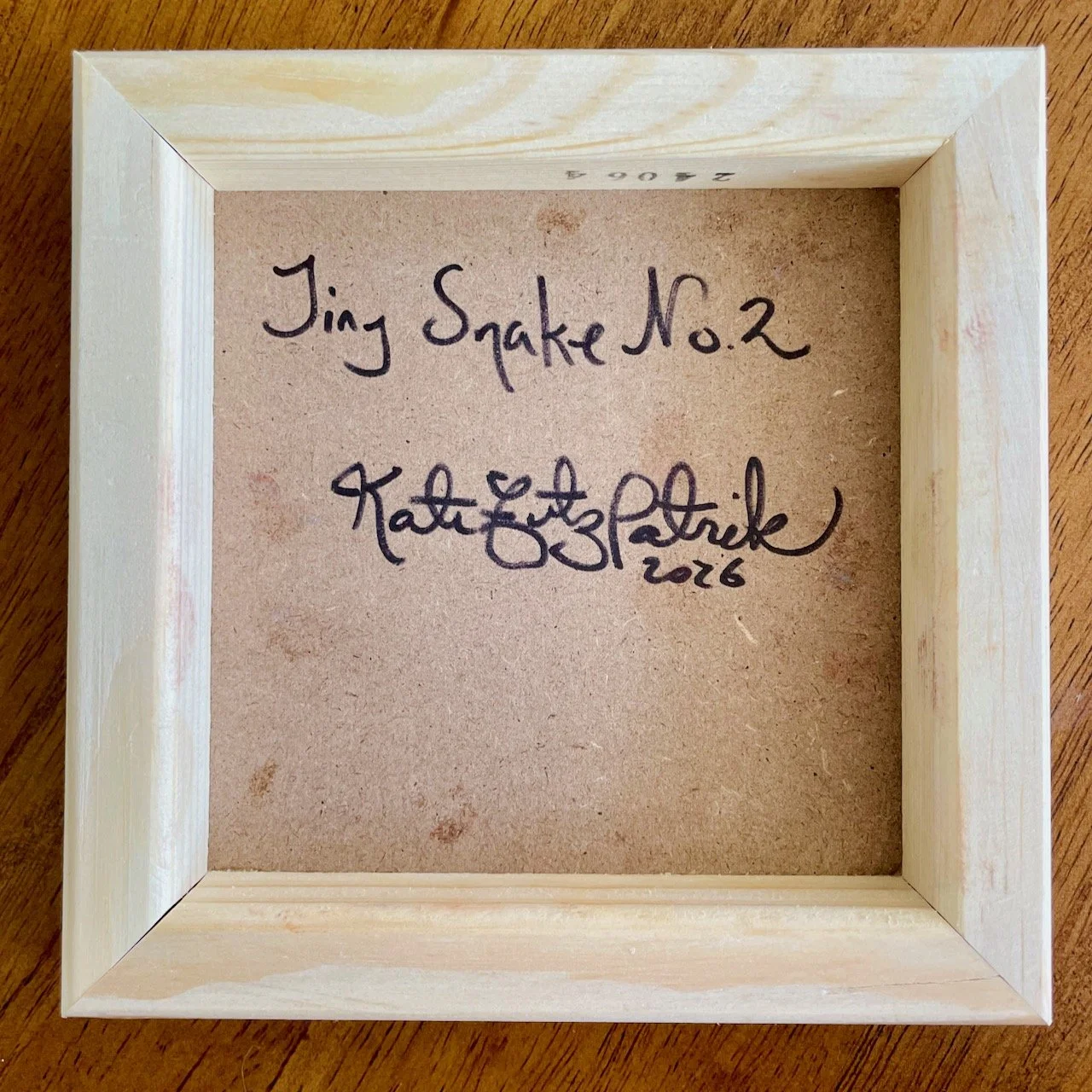 back of the cradled wood with writing that says tiny snake no.2 kate fitzpatrick 2026